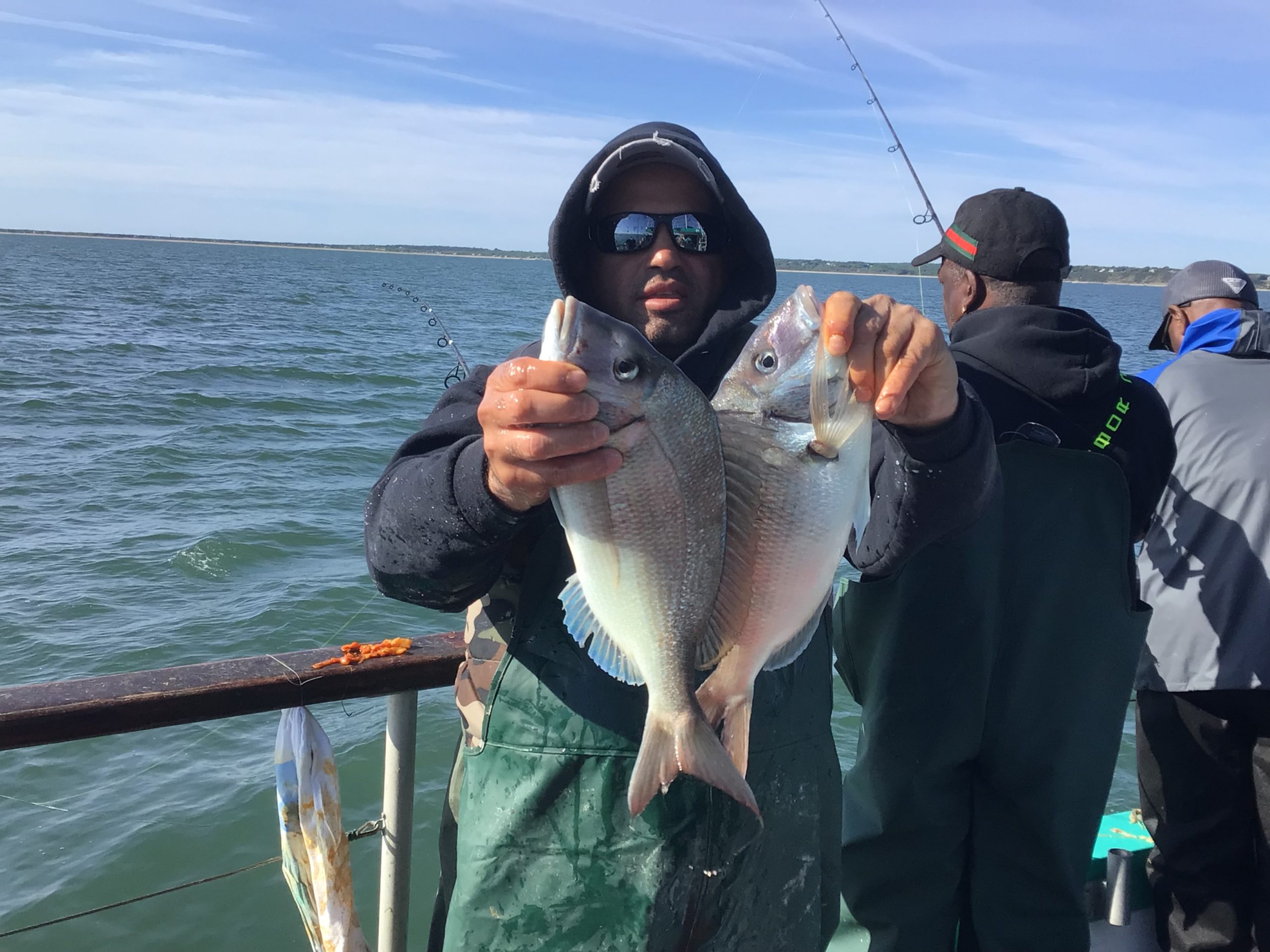 a person holding a fish in the water