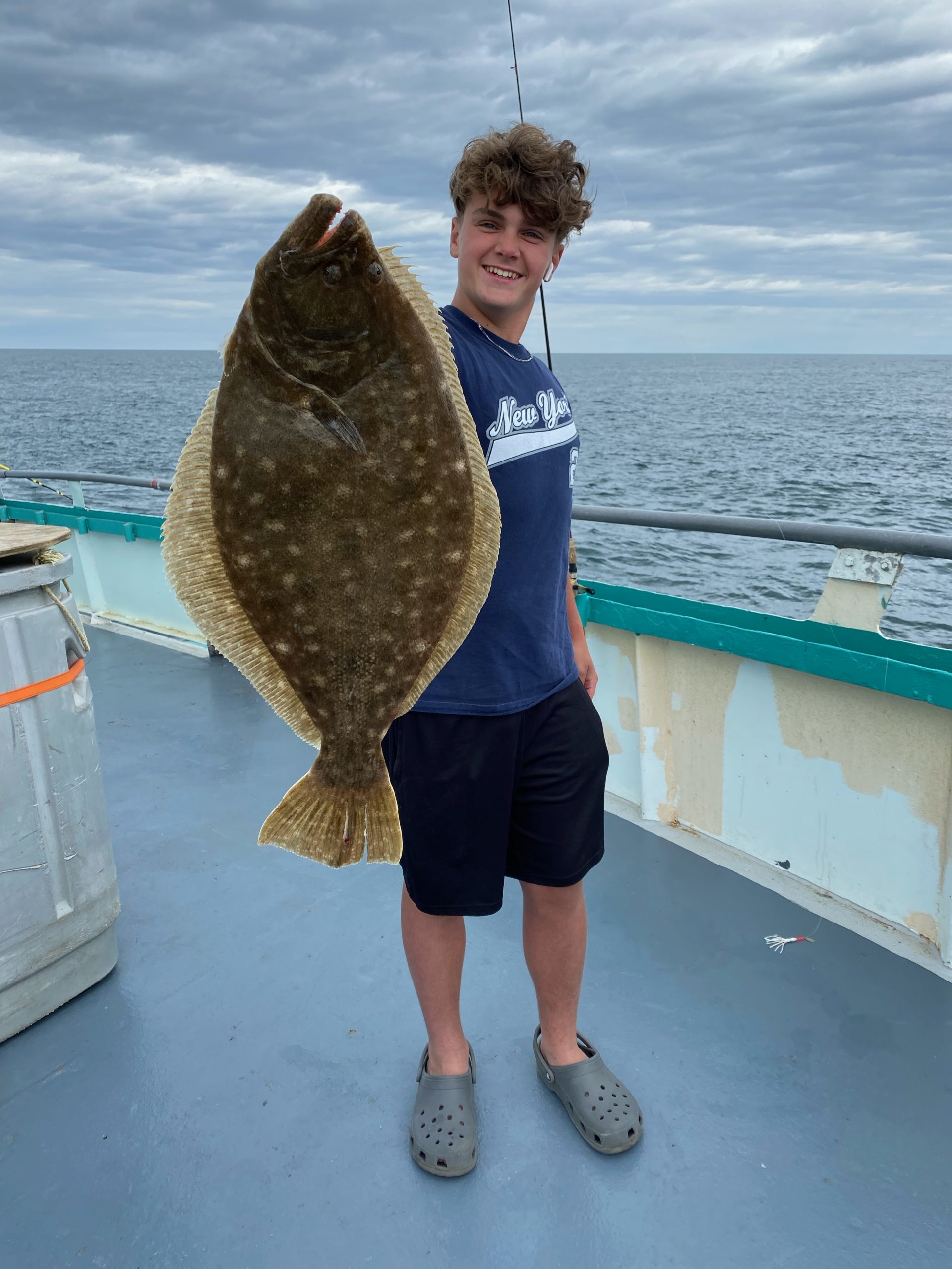 a man holding a fish in the water