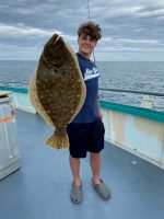 a man holding a fish in the water