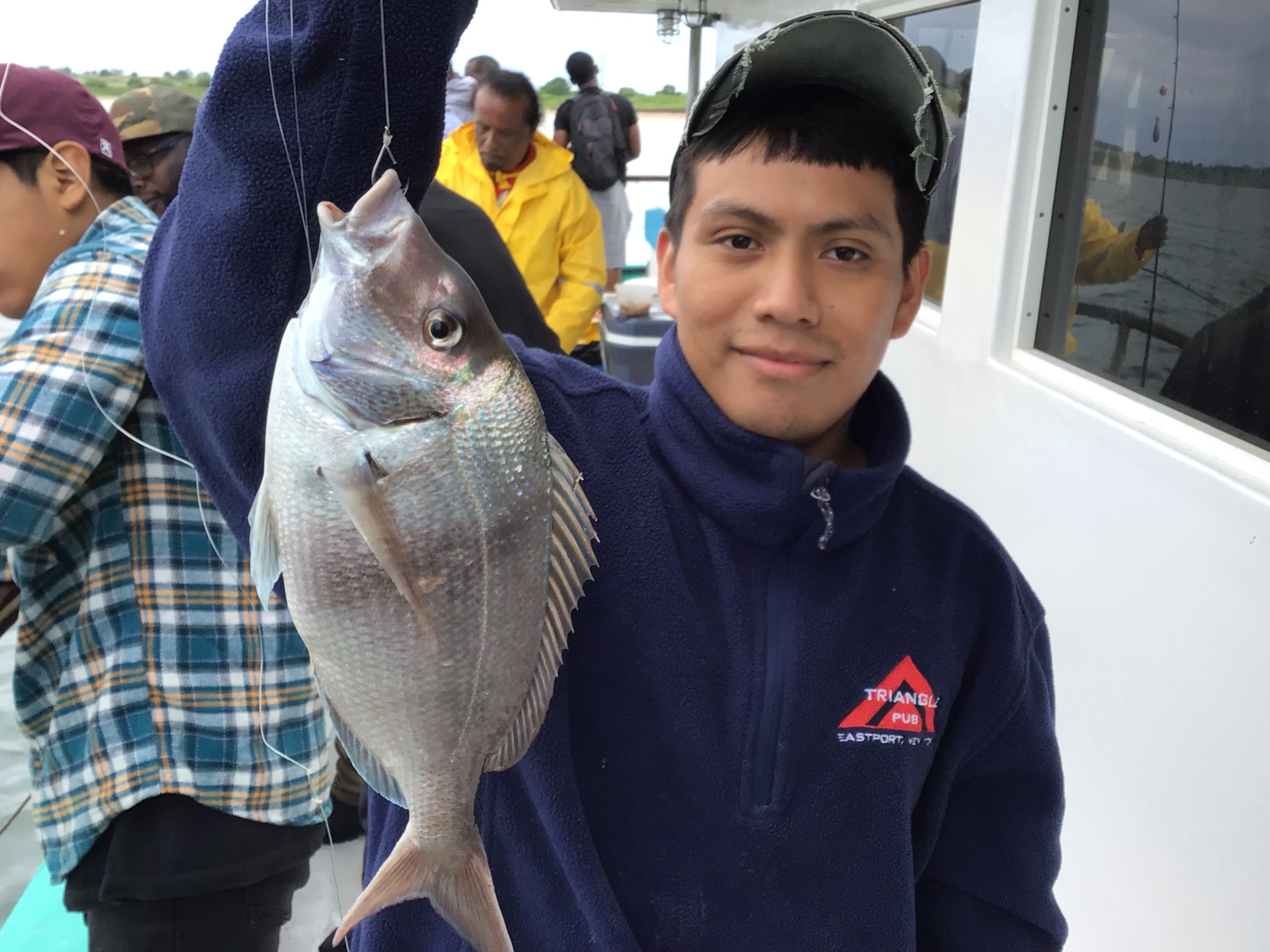 a young boy holding a fish