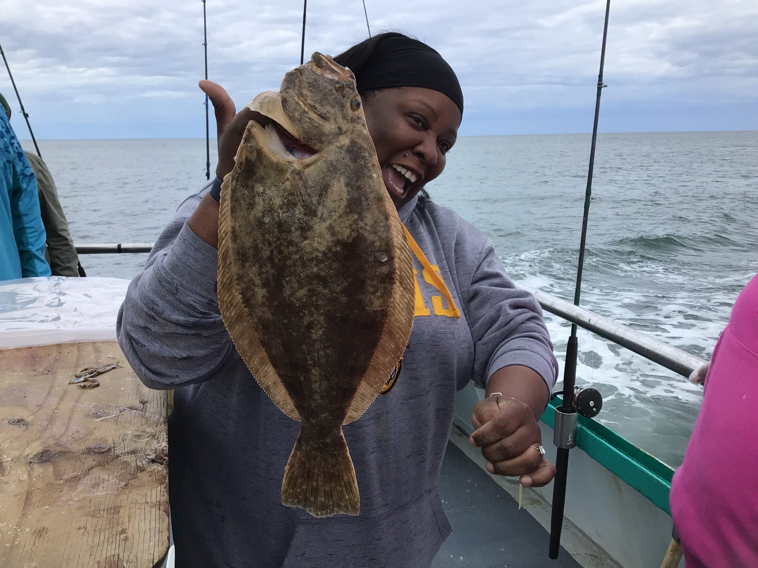 a man holding a fish in the water