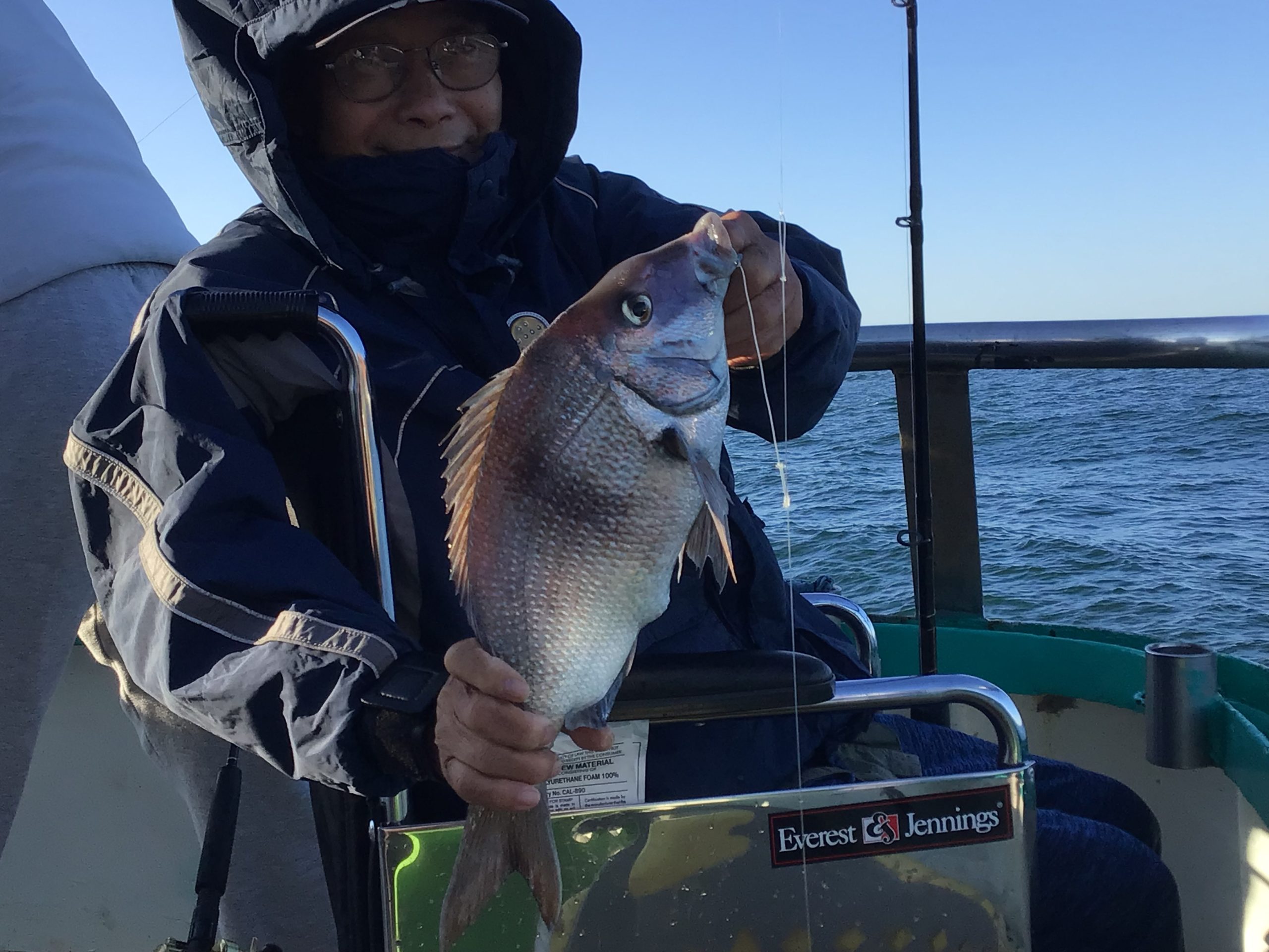 a person holding a fish in the water