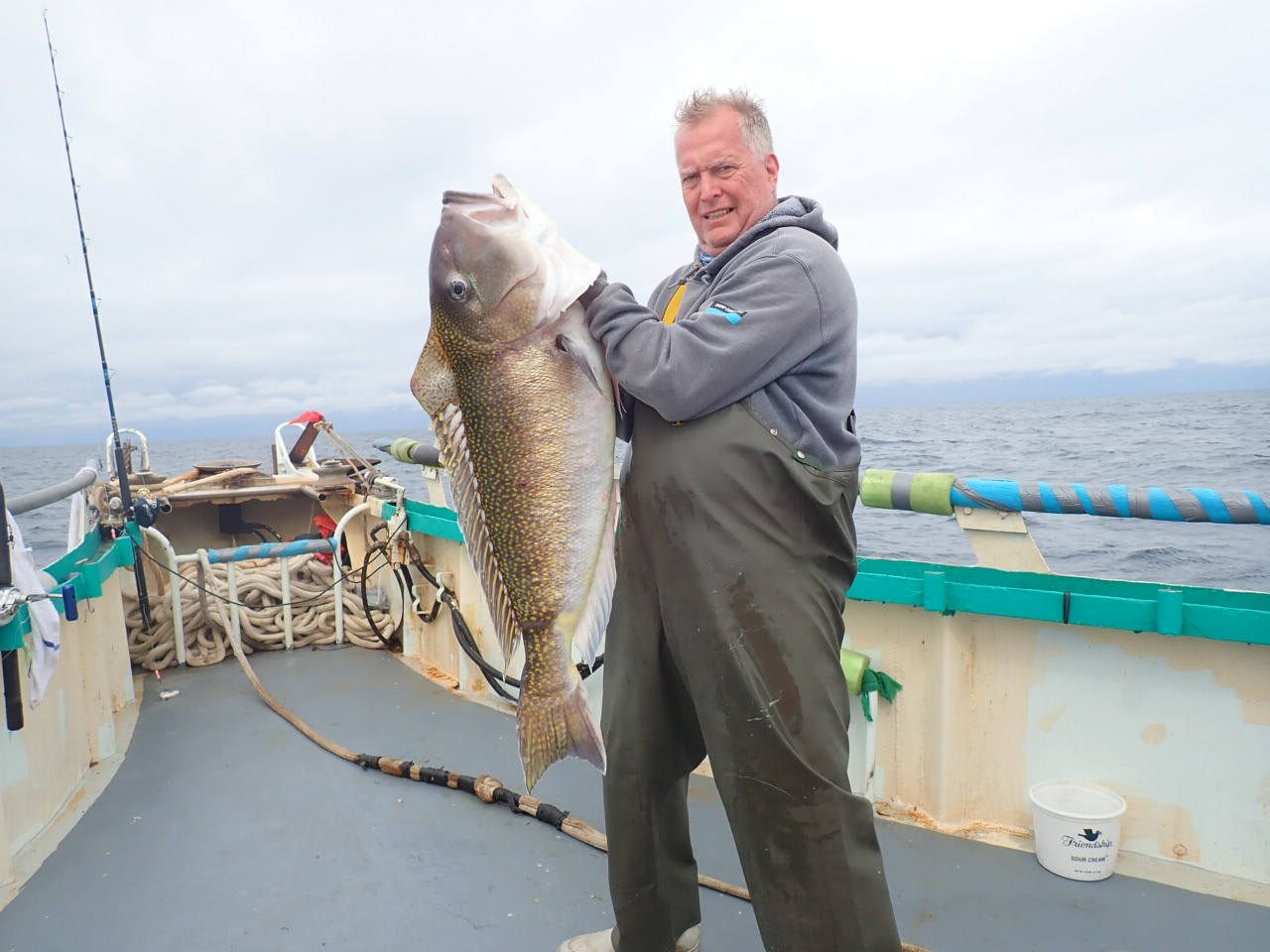 a man holding a fish in the water