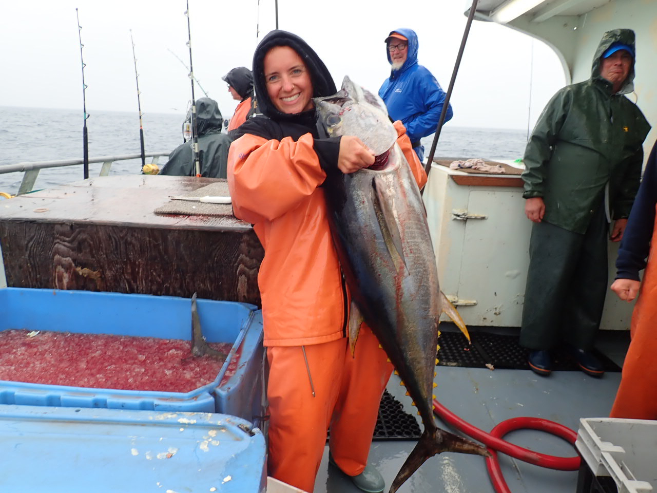 a person holding a fish on a boat