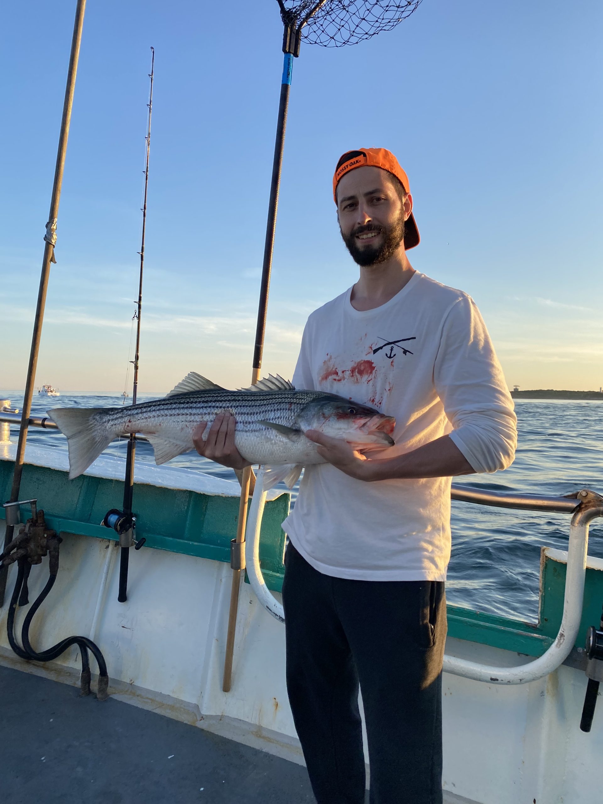 a man holding a fish in the water