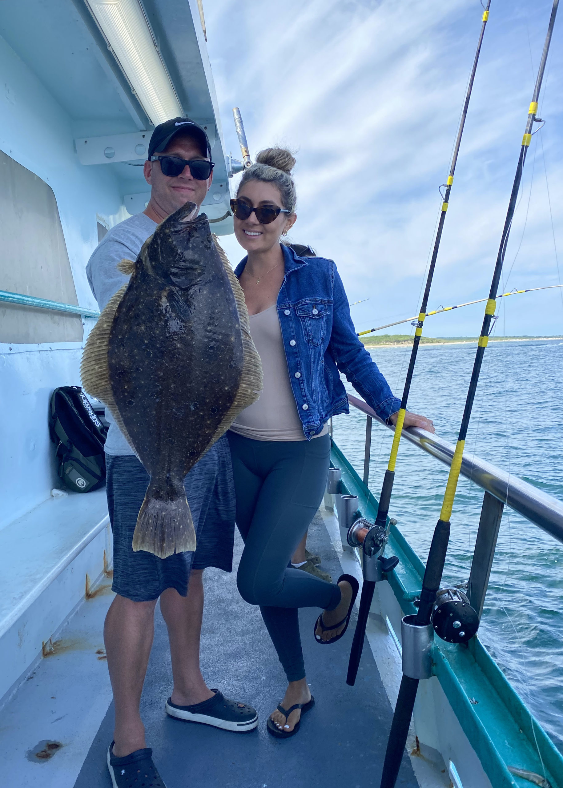 a man and a woman riding on the back of a boat