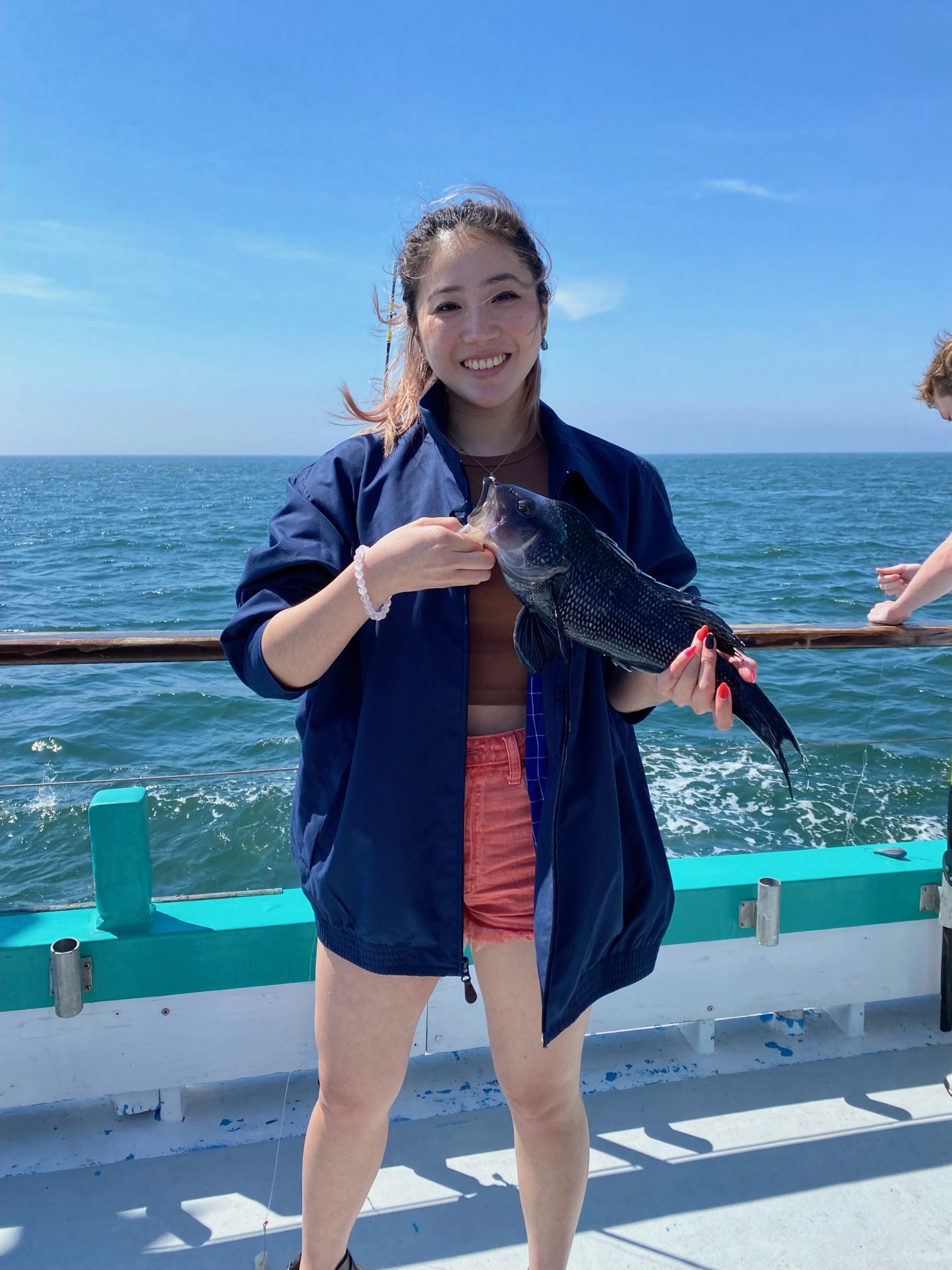 a woman standing next to a body of water