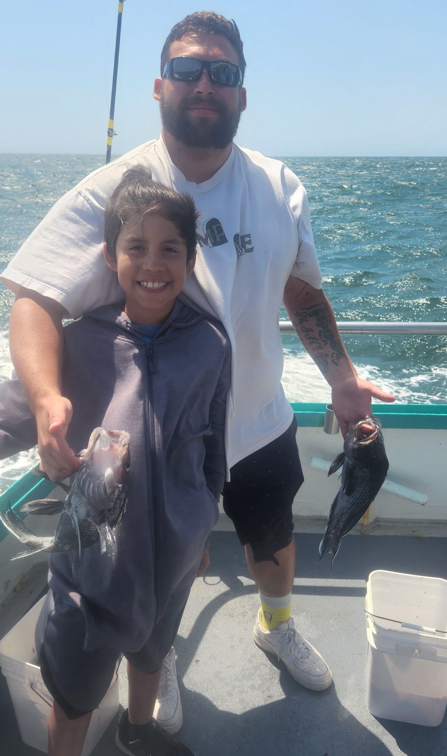 a man holding a fish in the water