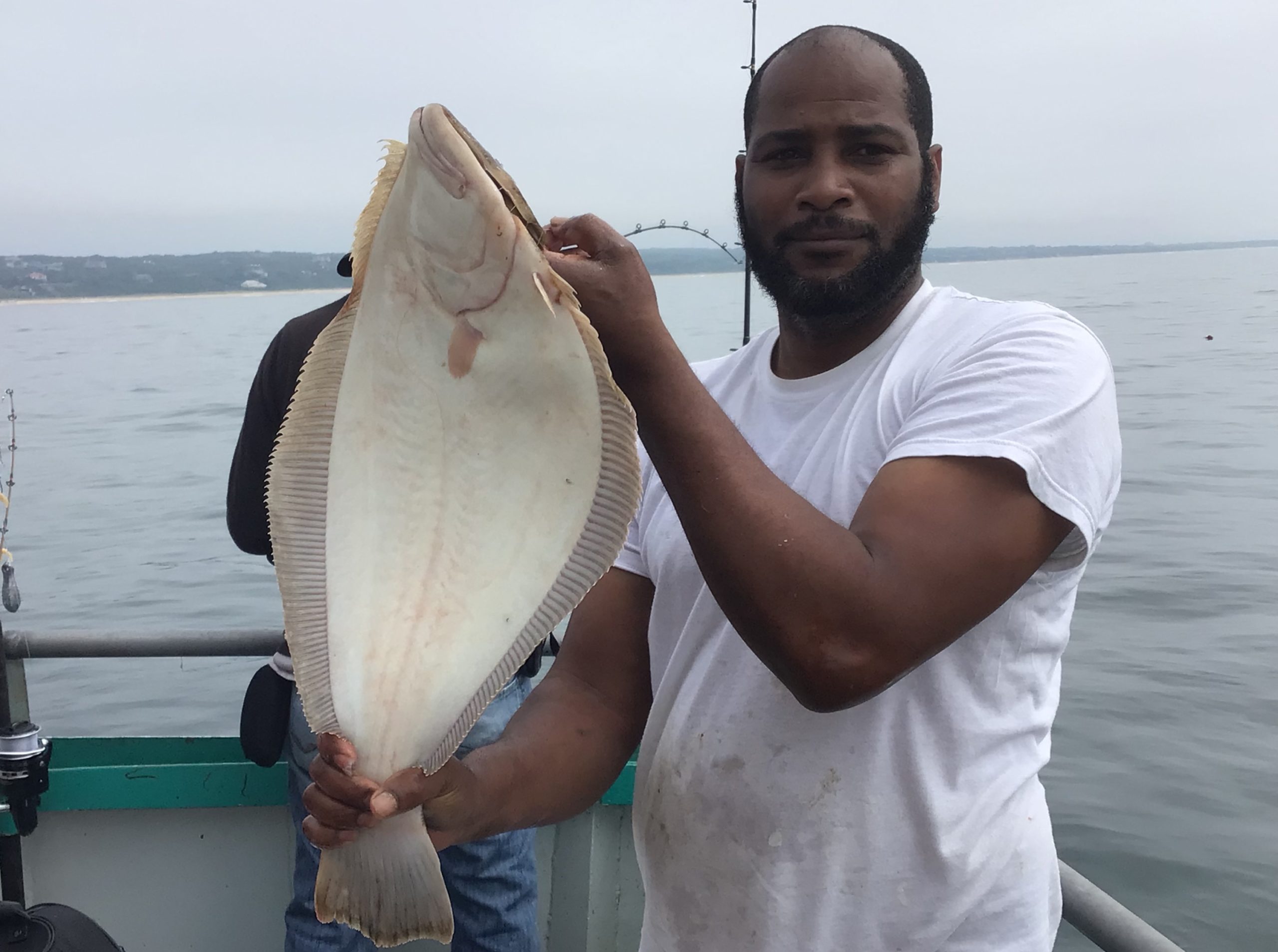a man holding a fish in the water