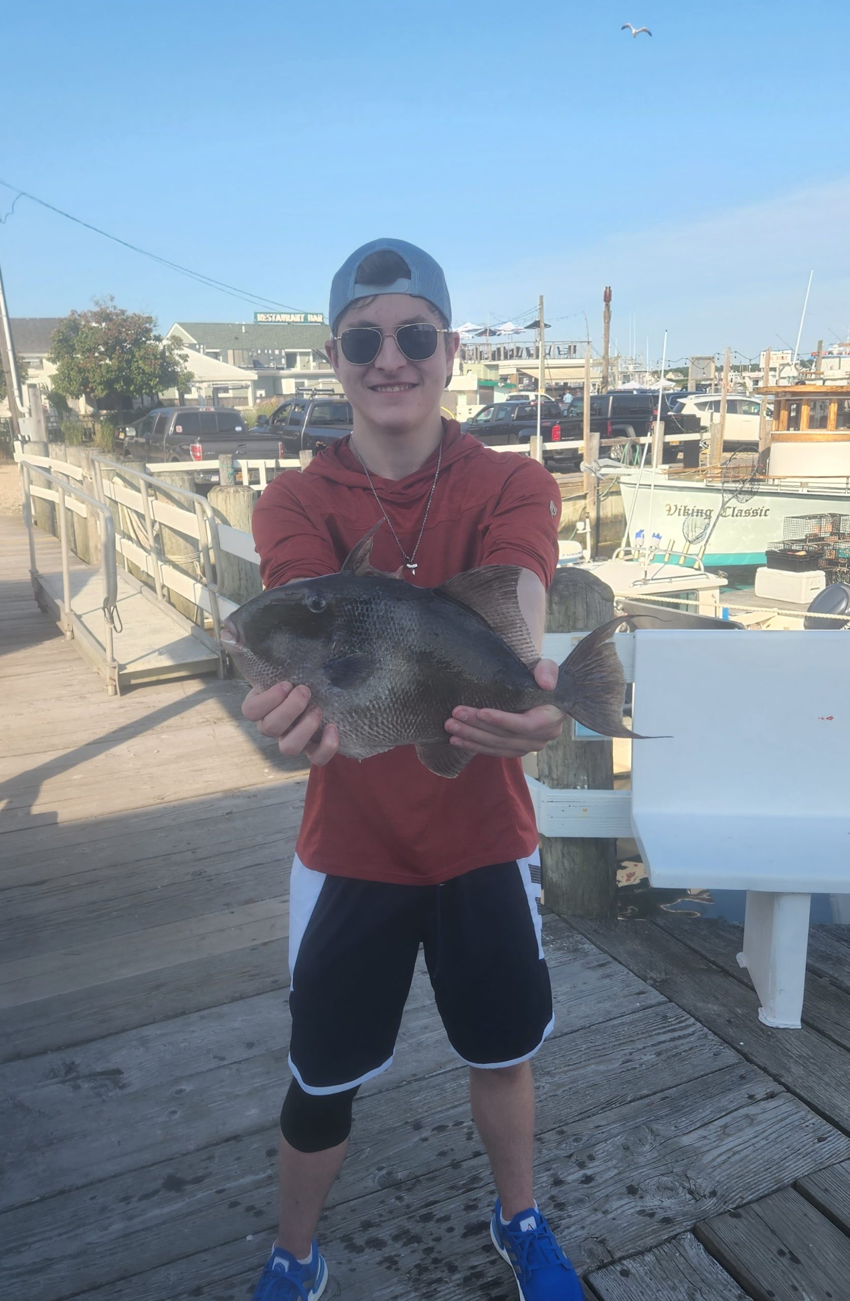 a young boy holding a fish