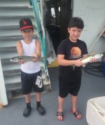 a group of people standing in front of a cake