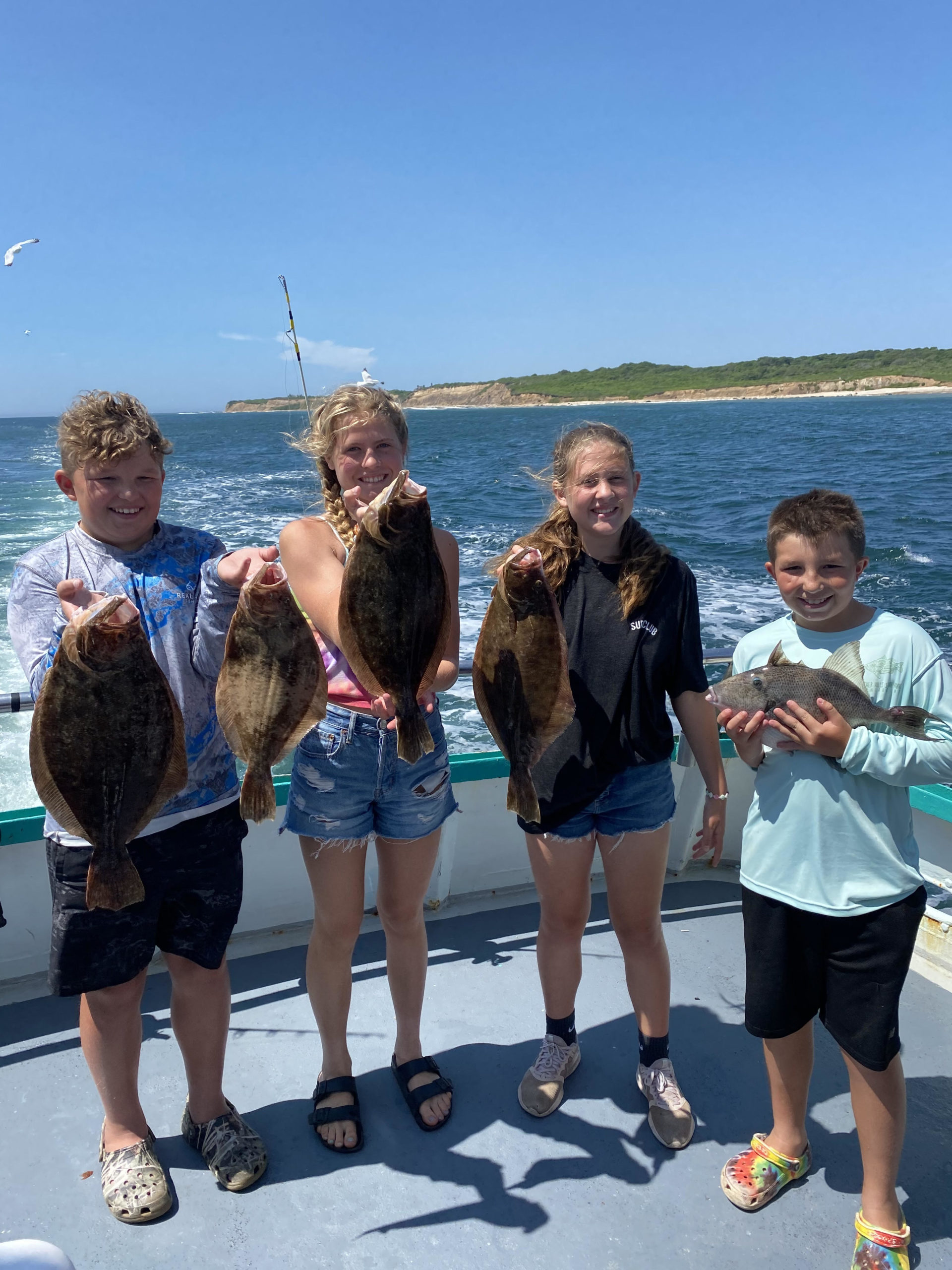 a group of people standing next to a lake