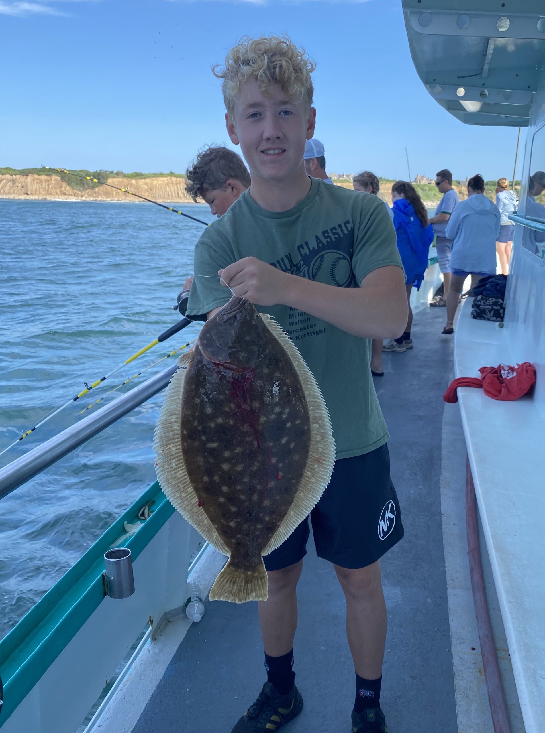 a person standing next to a body of water