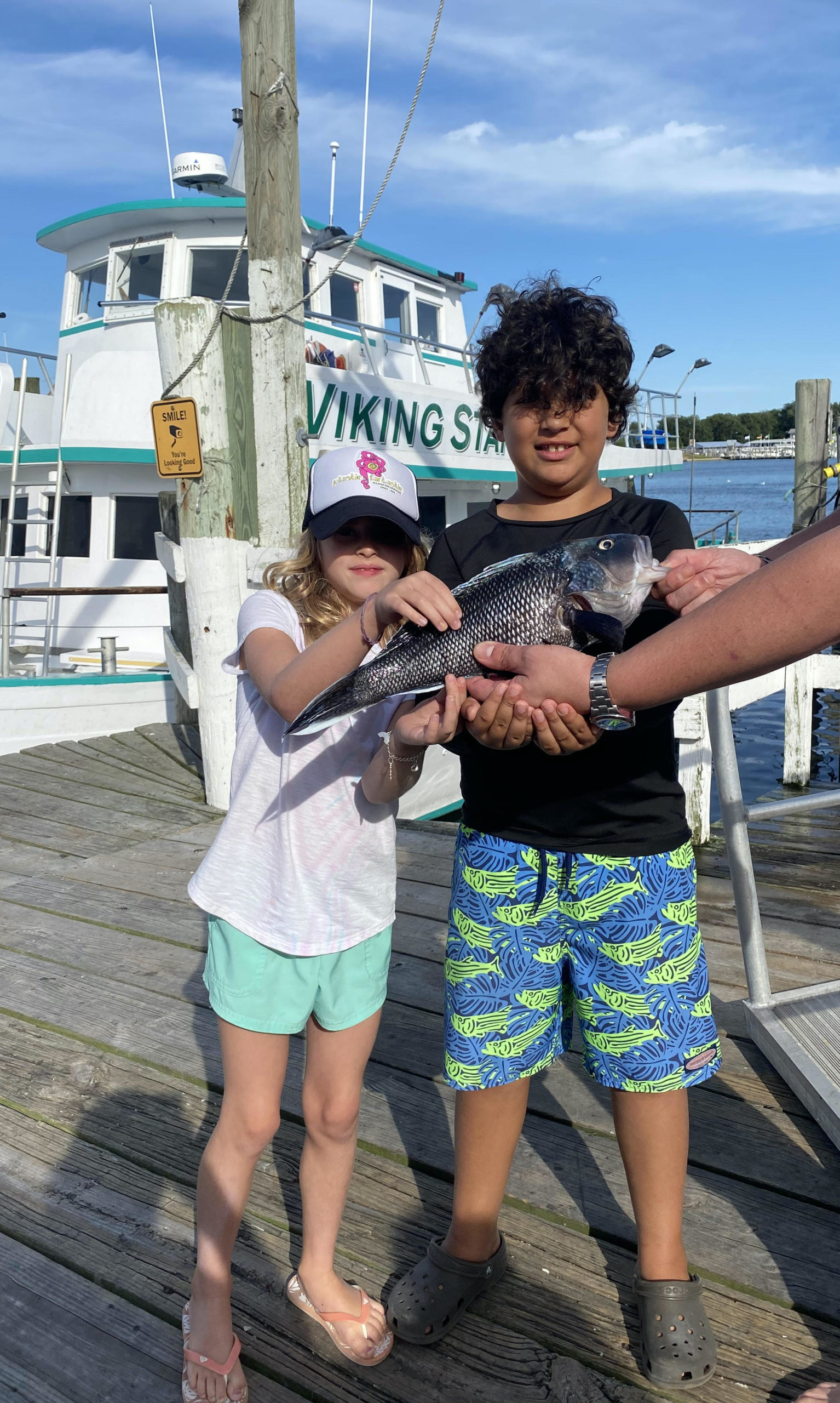a hand holding a little girl posing for a picture
