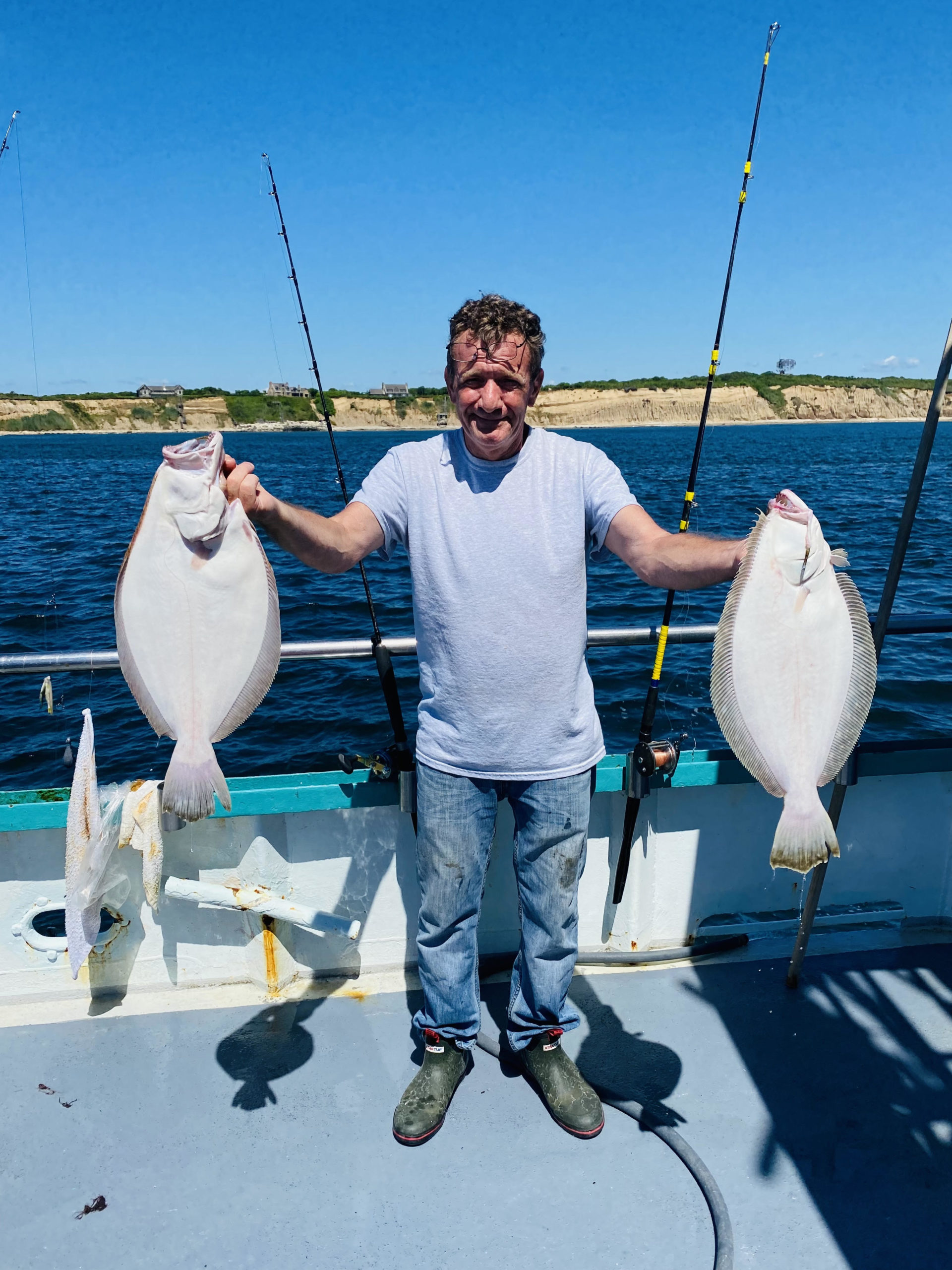 a man holding a fish in the water