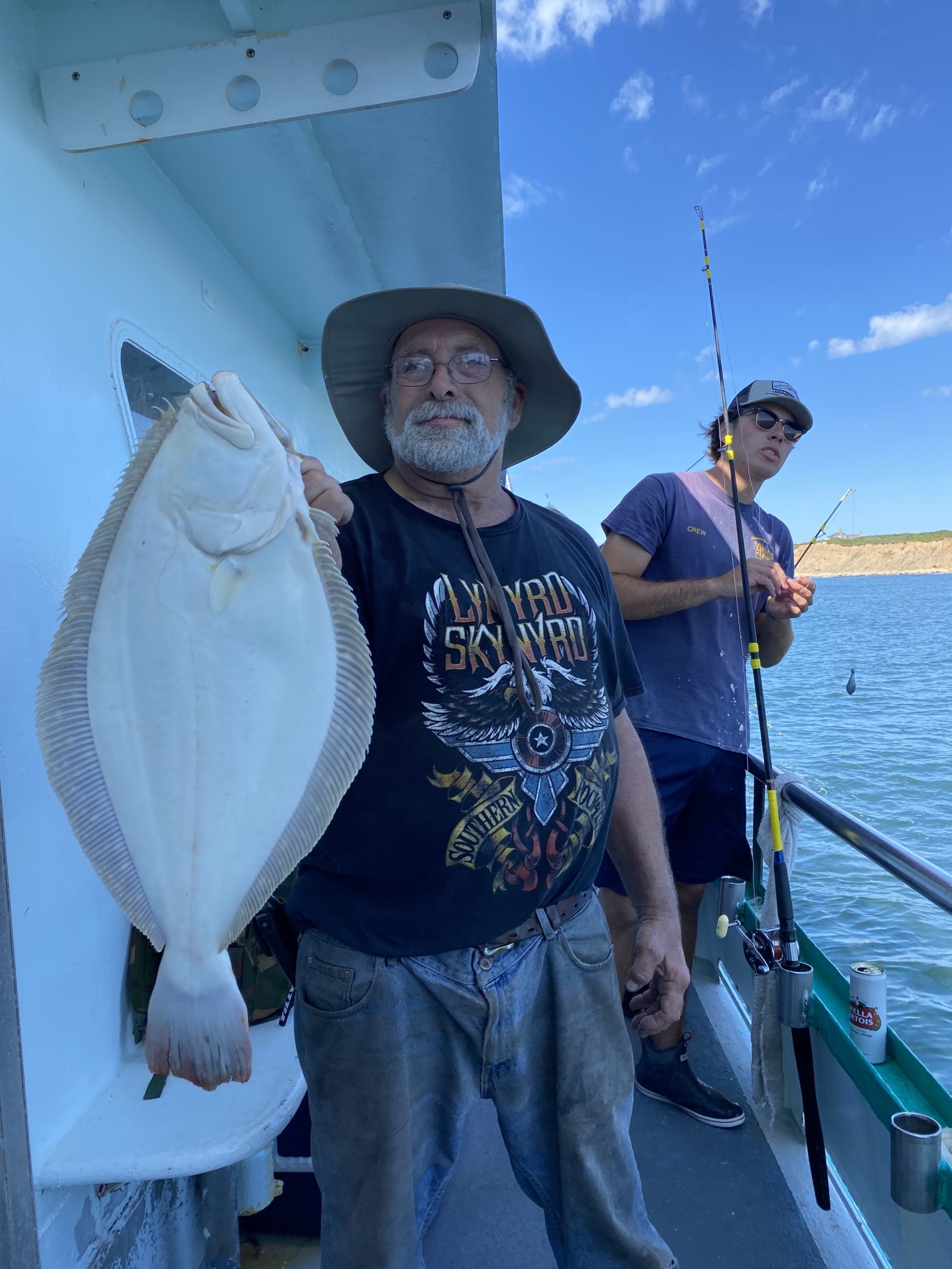 a person holding a fish on a boat