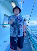 a person standing next to a boat