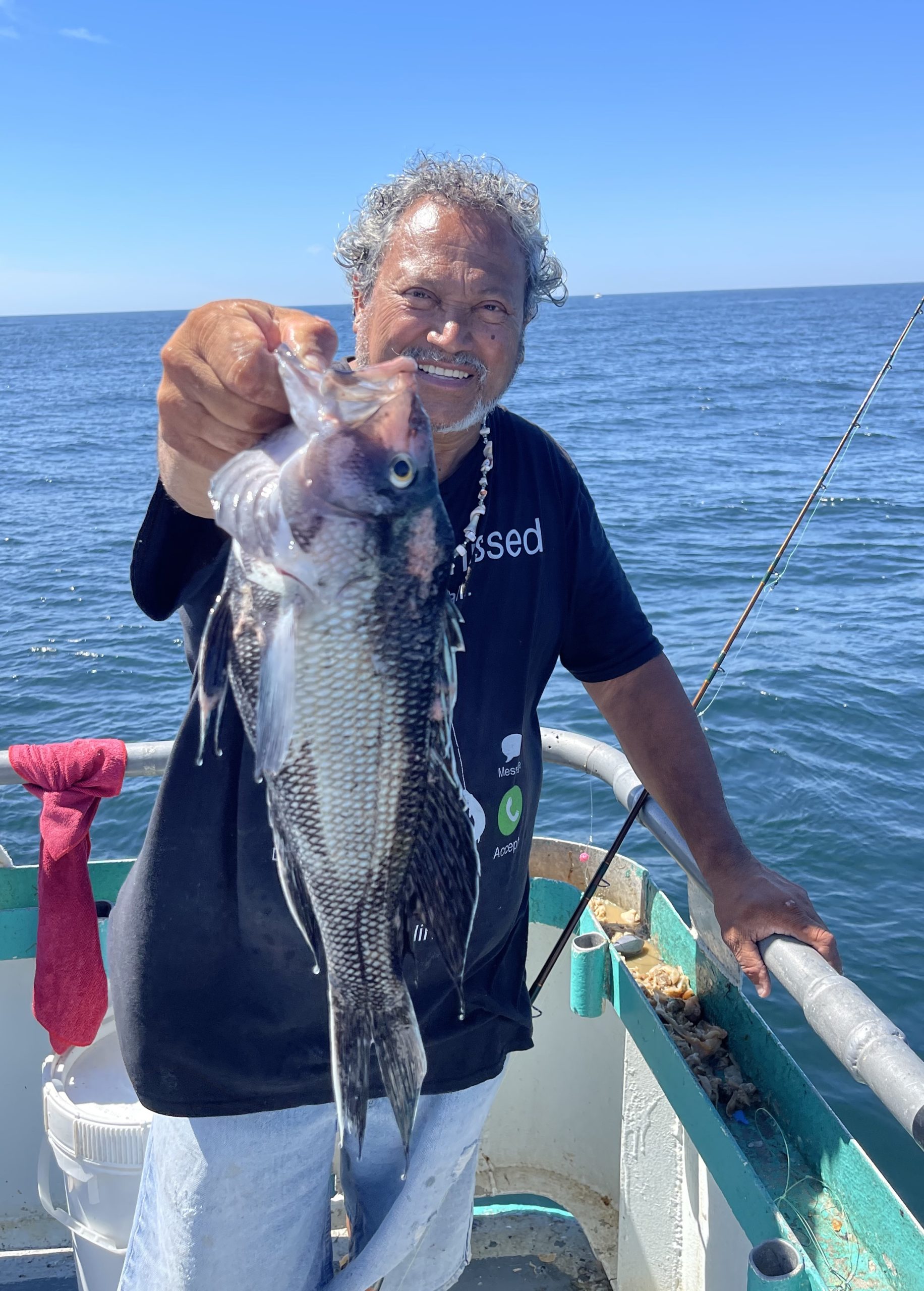 a man holding a fish in the water