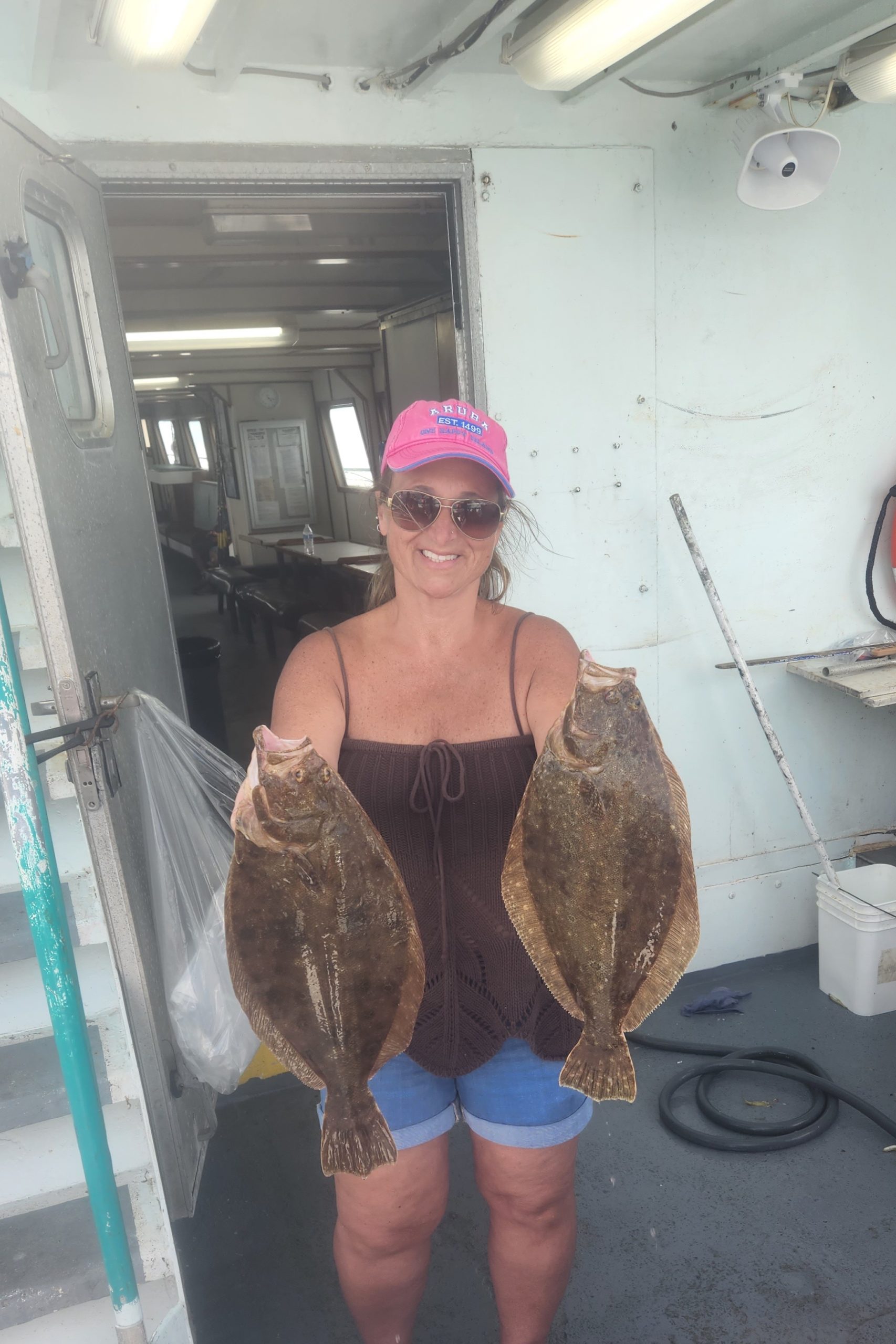 a woman standing in front of a stuffed toy posing for the camera