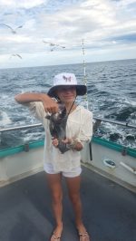 a person standing next to a body of water