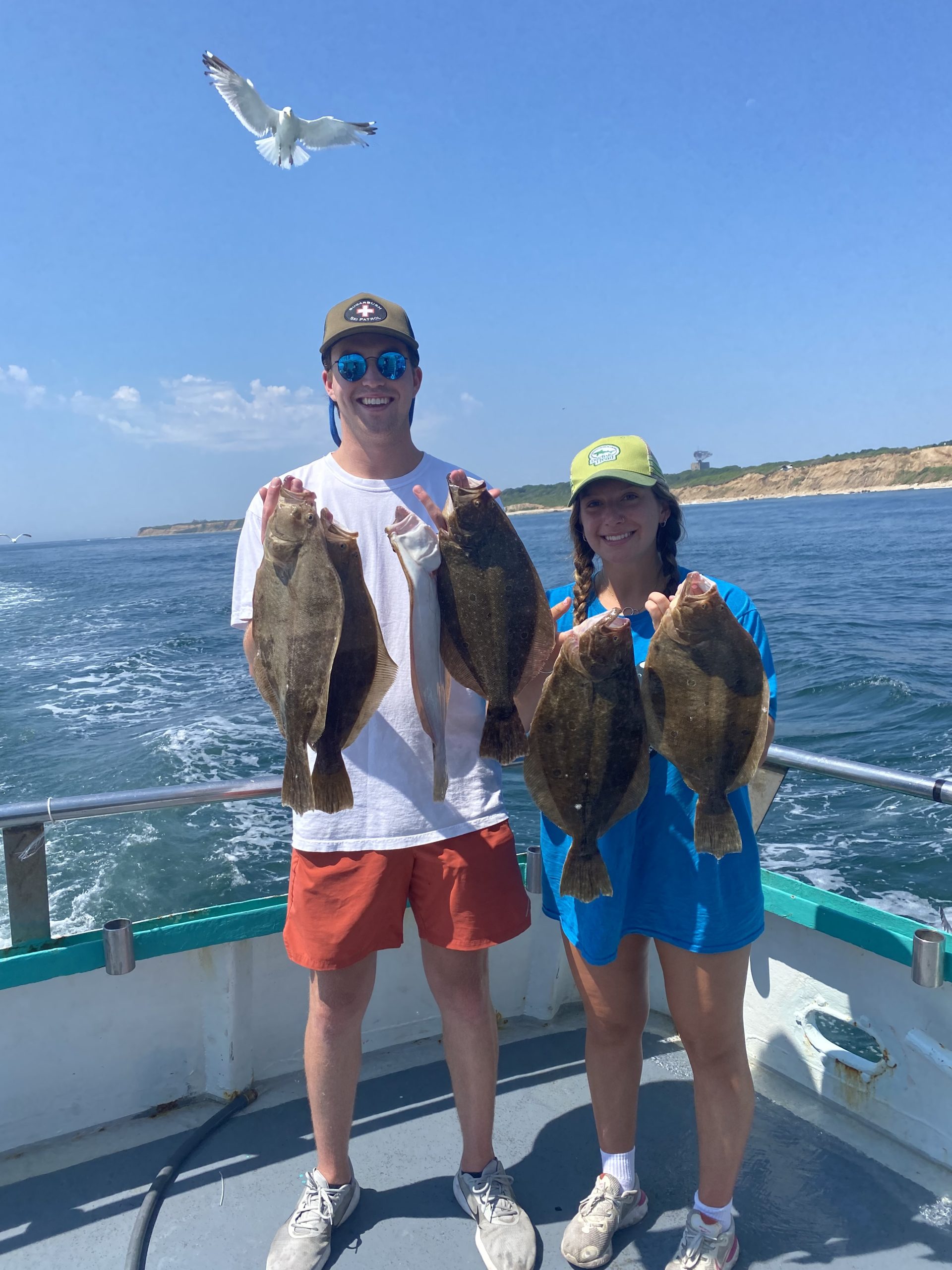 a group of people standing next to a body of water