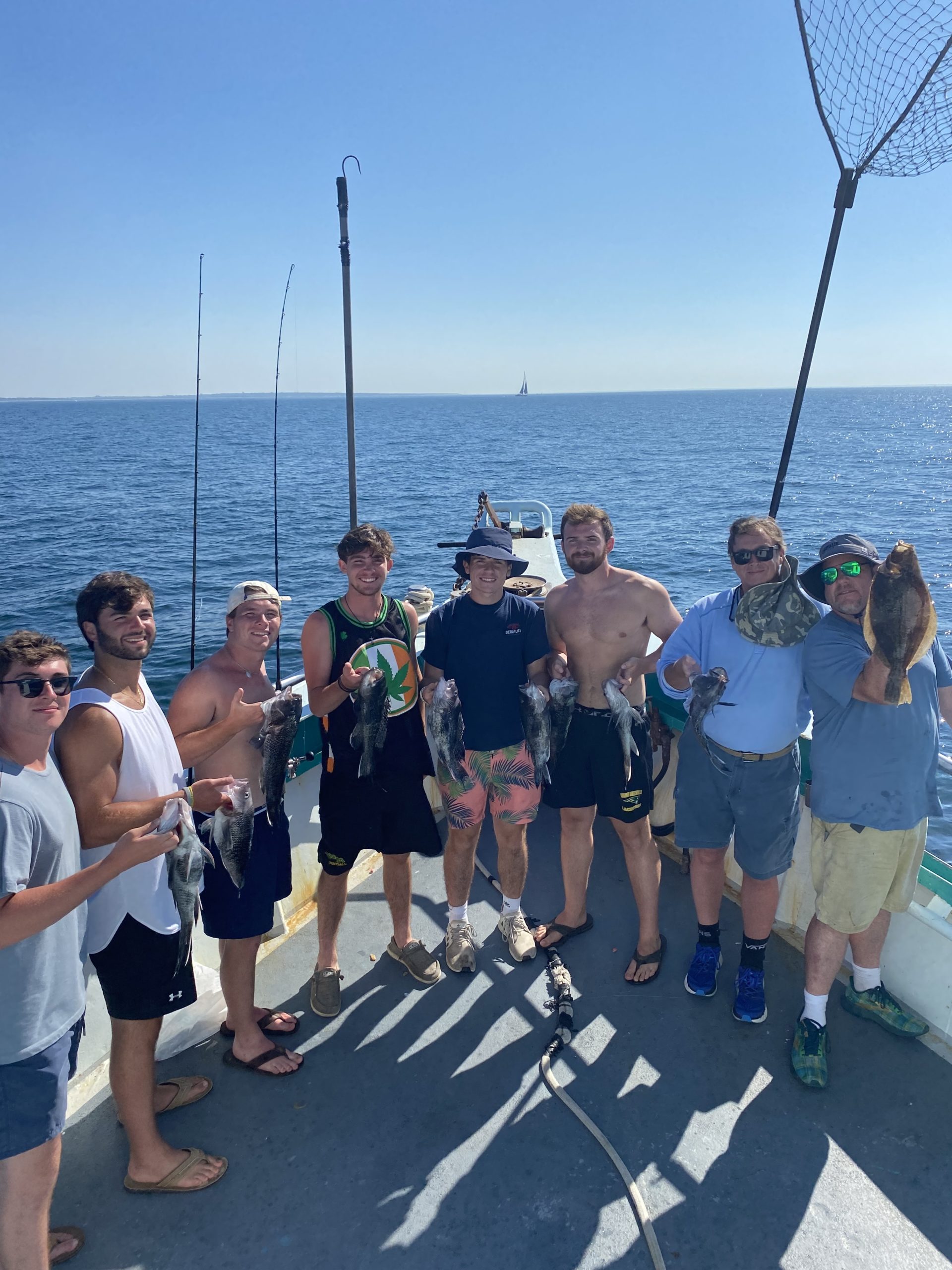 a group of people standing next to a body of water