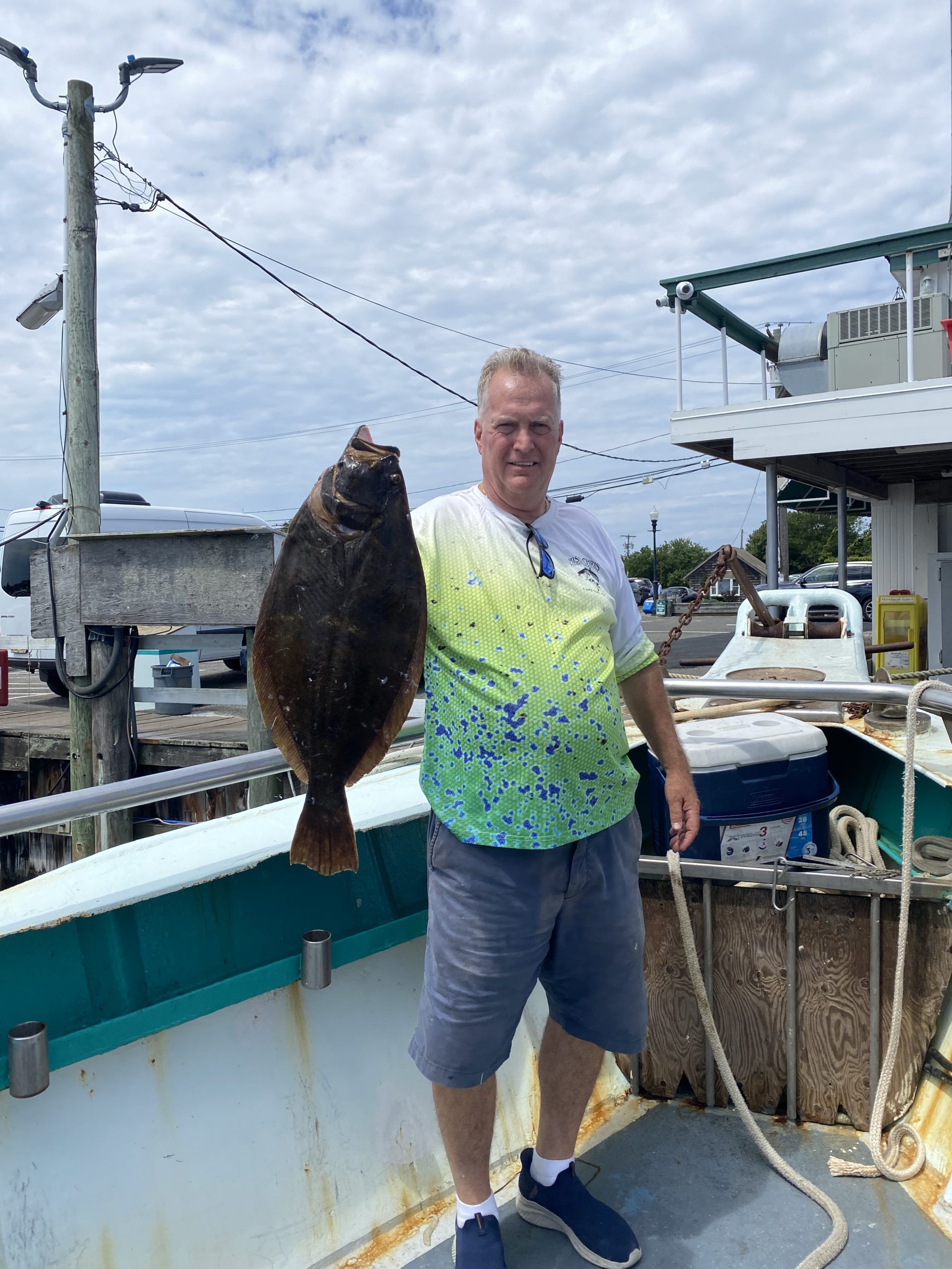 a person holding a fish on a boat