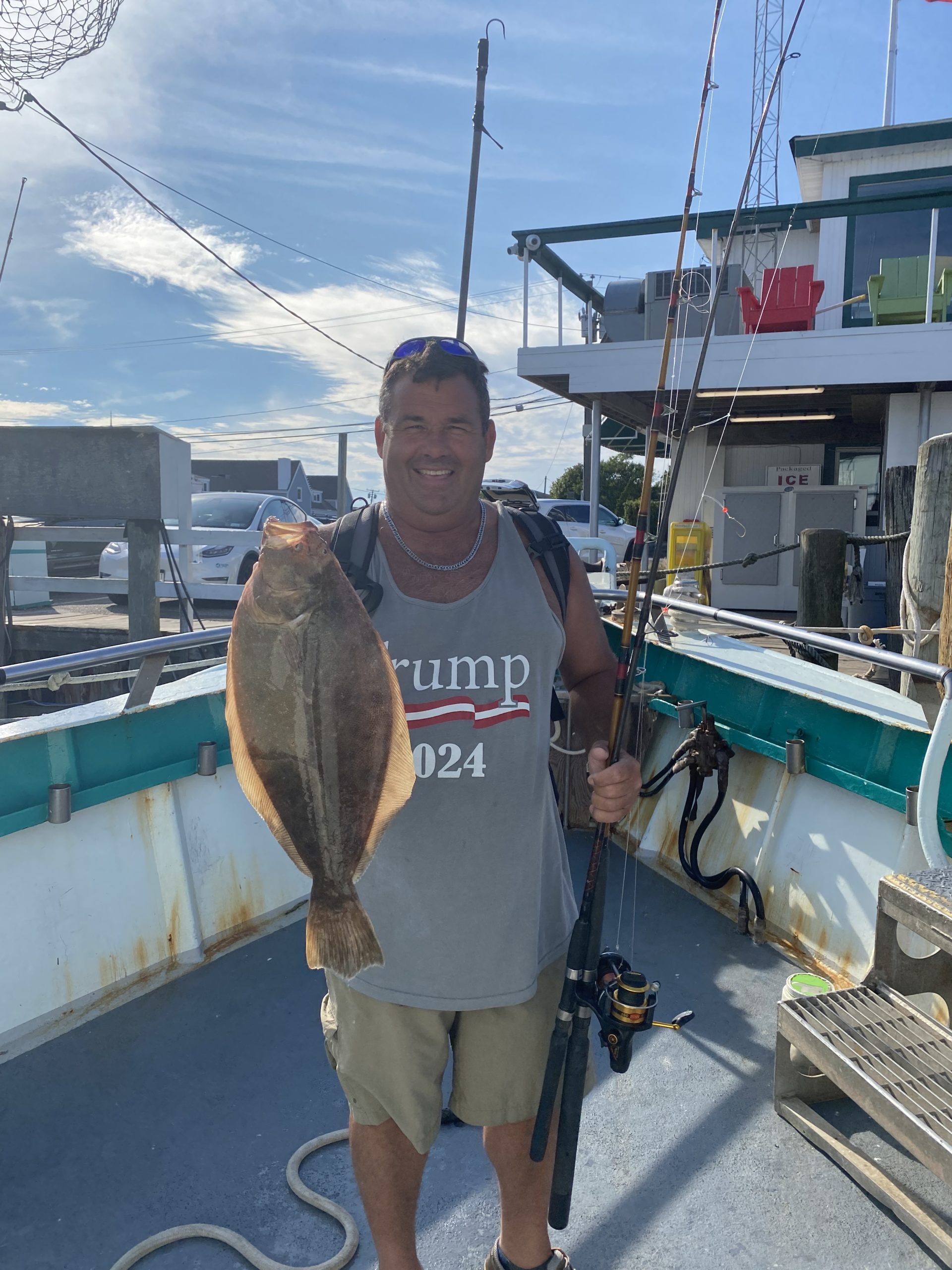 a man holding a fish on a boat