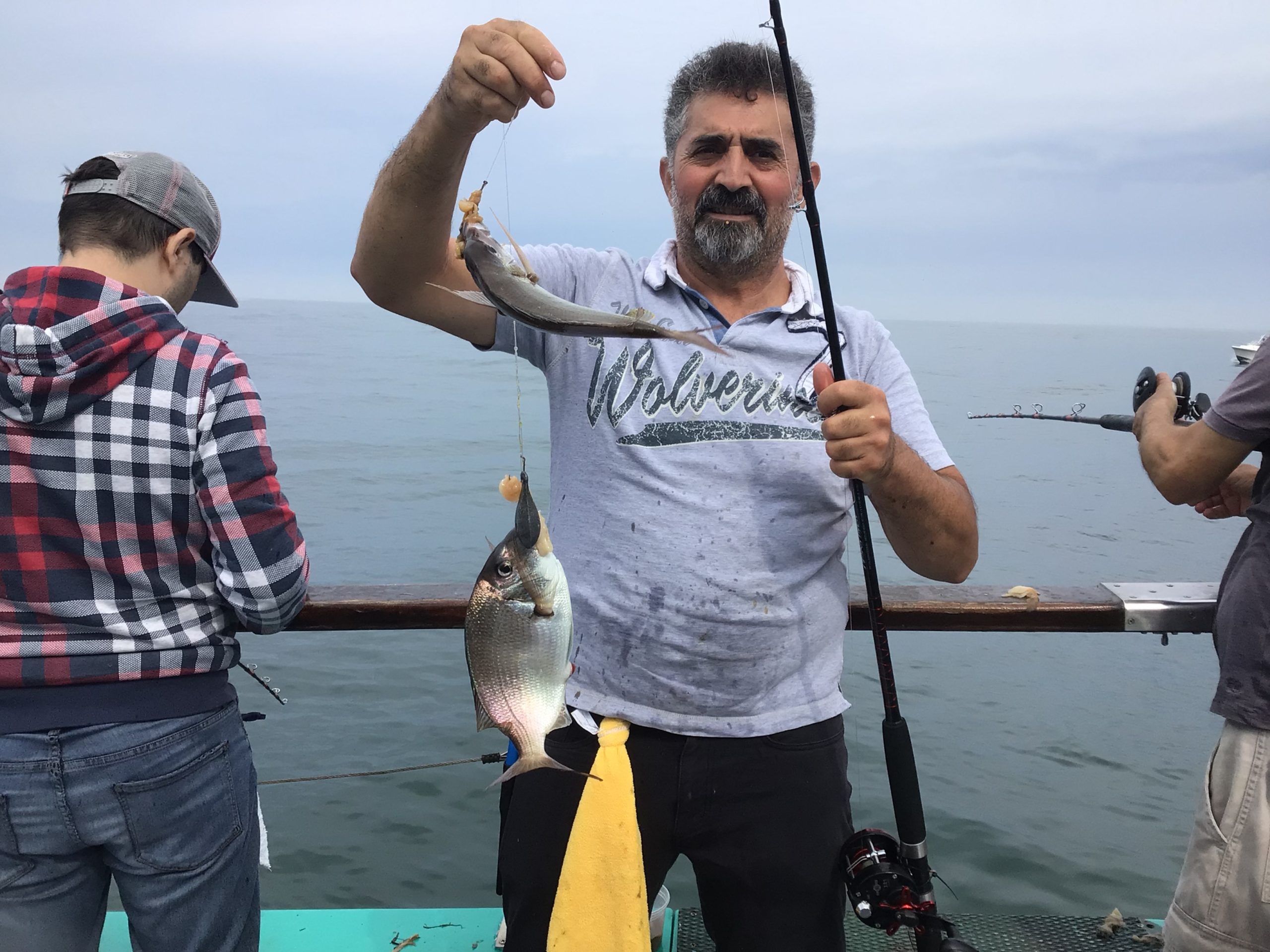 a man holding a fish in the water