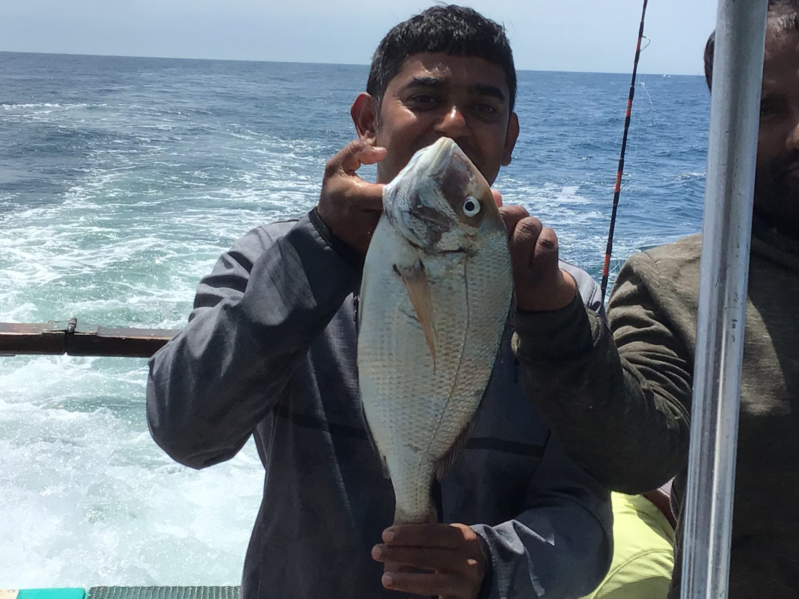 a man holding a fish in the water