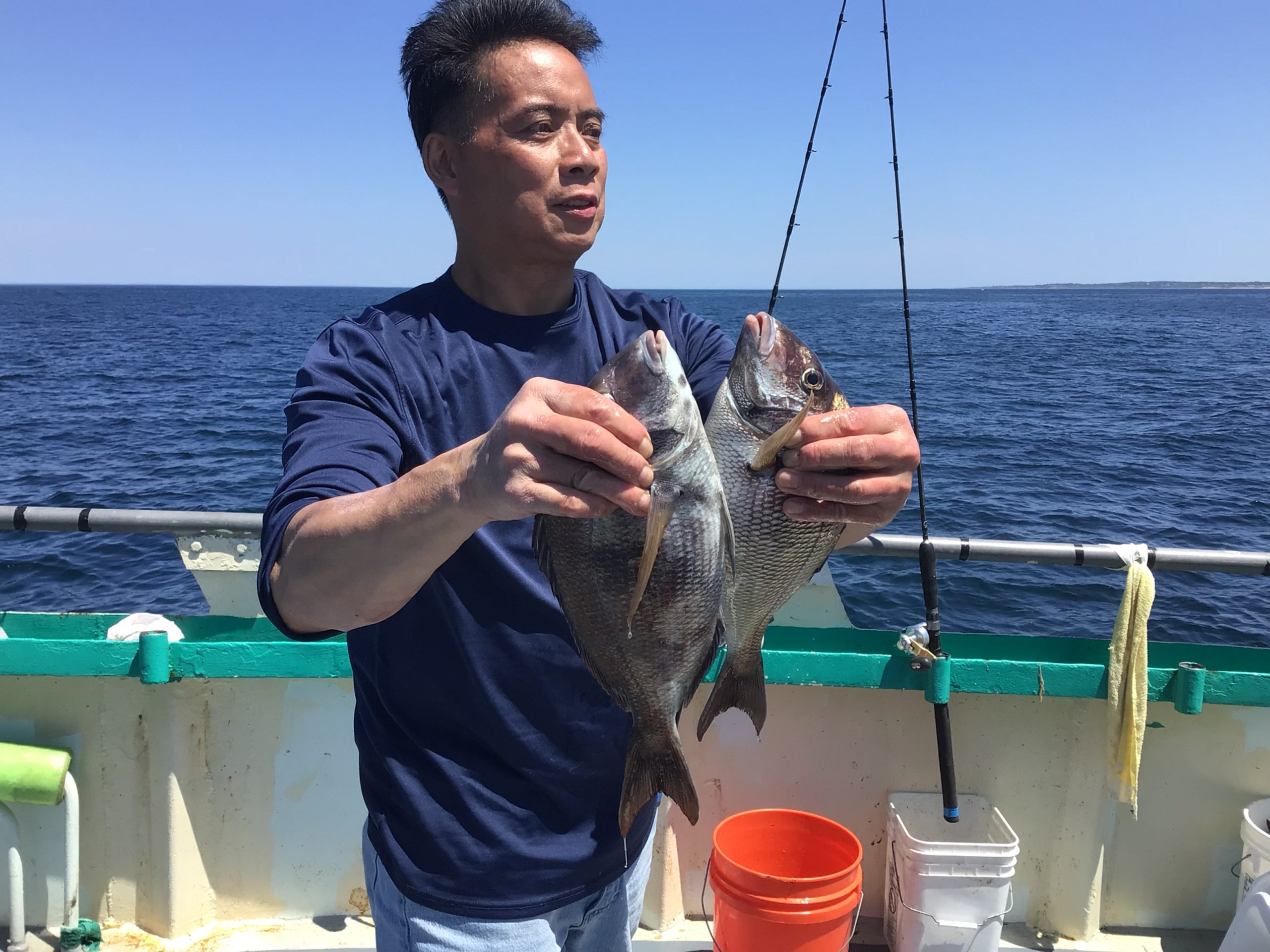 a man holding a fish in the water
