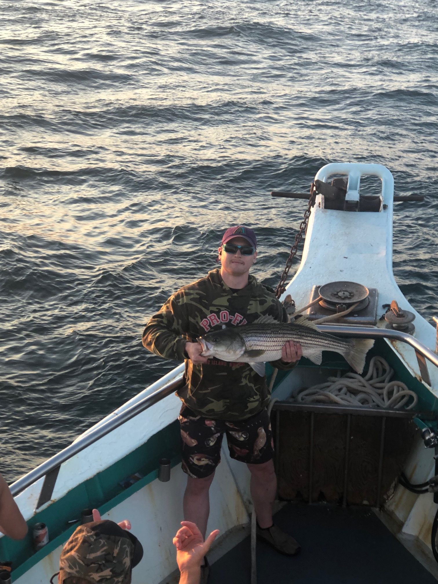 a man standing next to a body of water