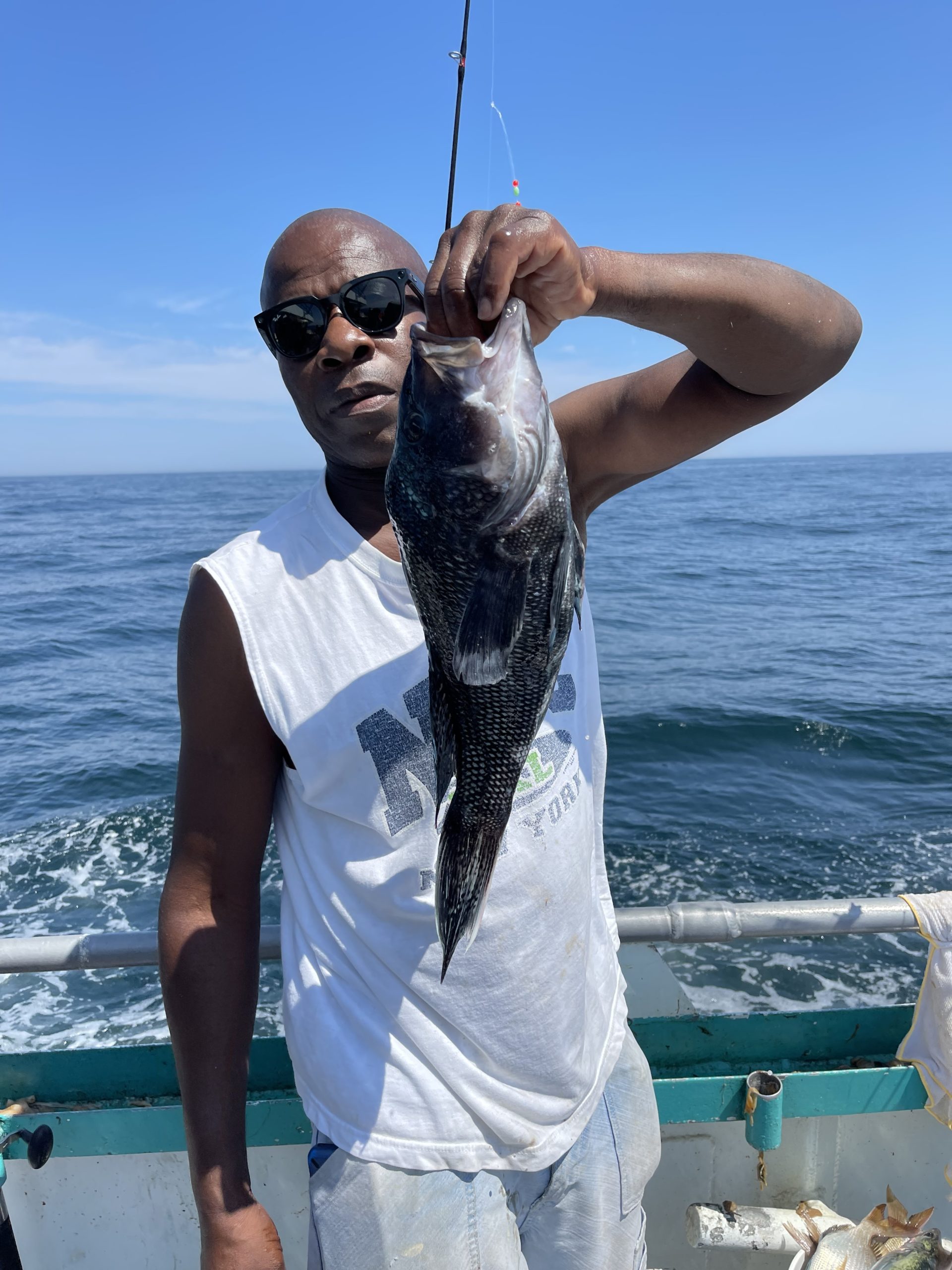 a man holding a fish in the water