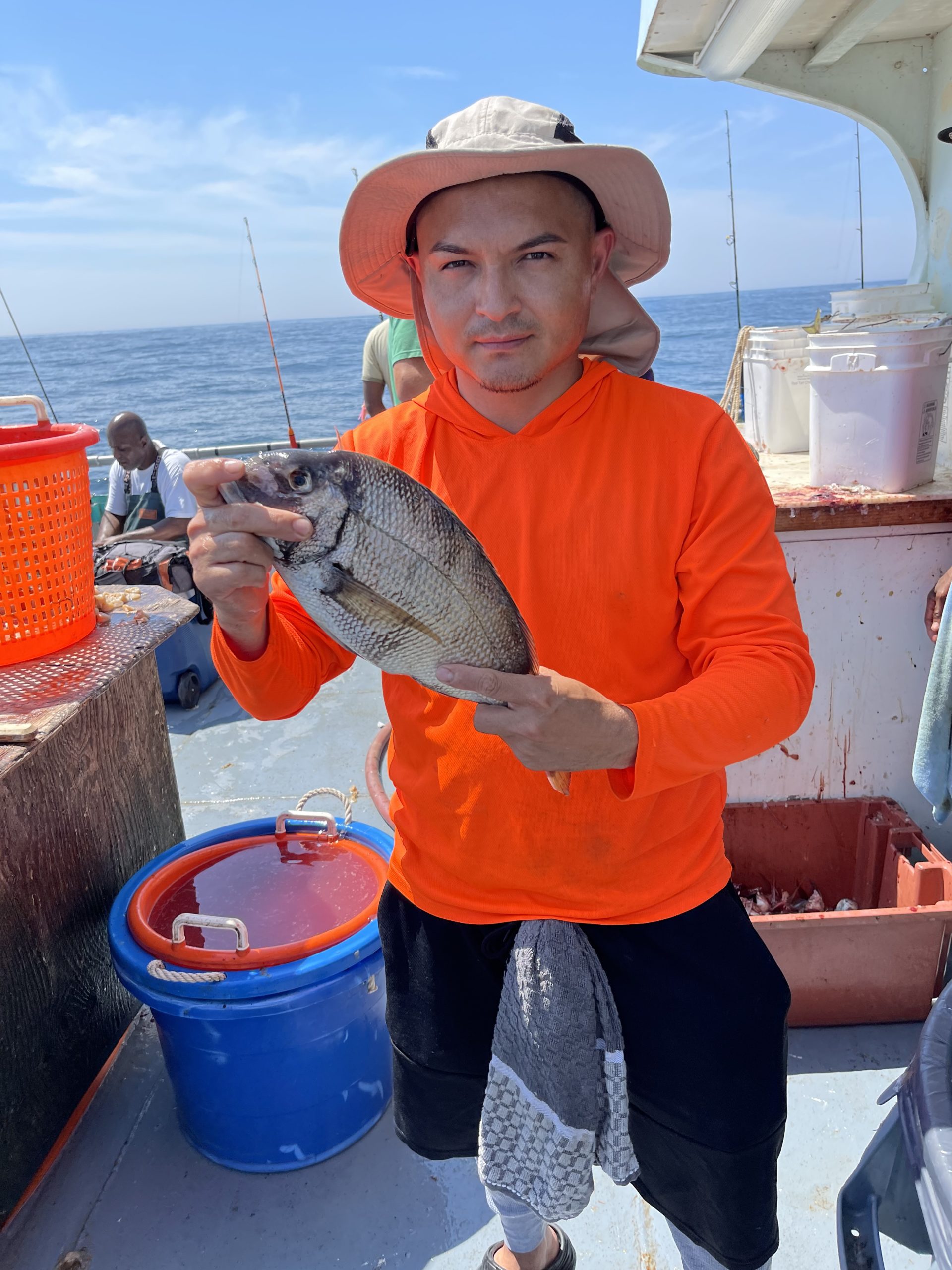 a person holding a fish in the water