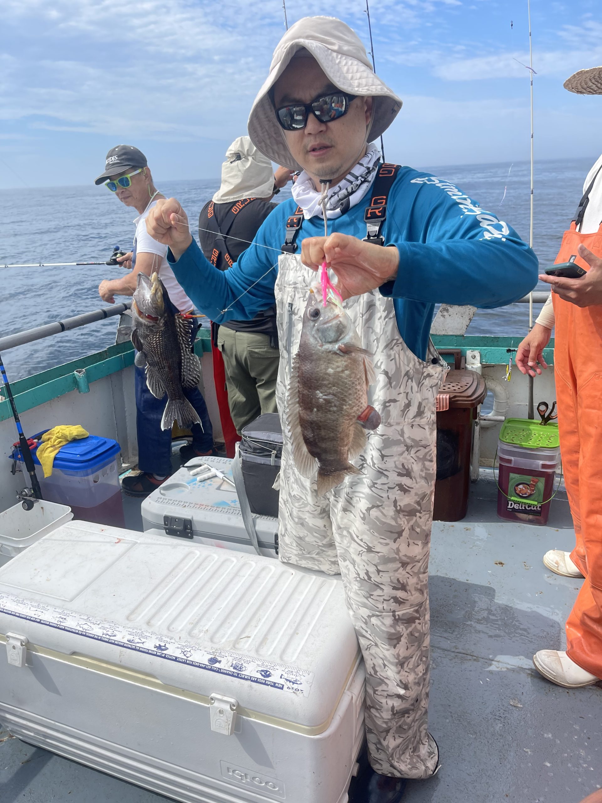 a man and a woman holding a fish