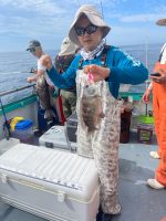 a man and a woman holding a fish