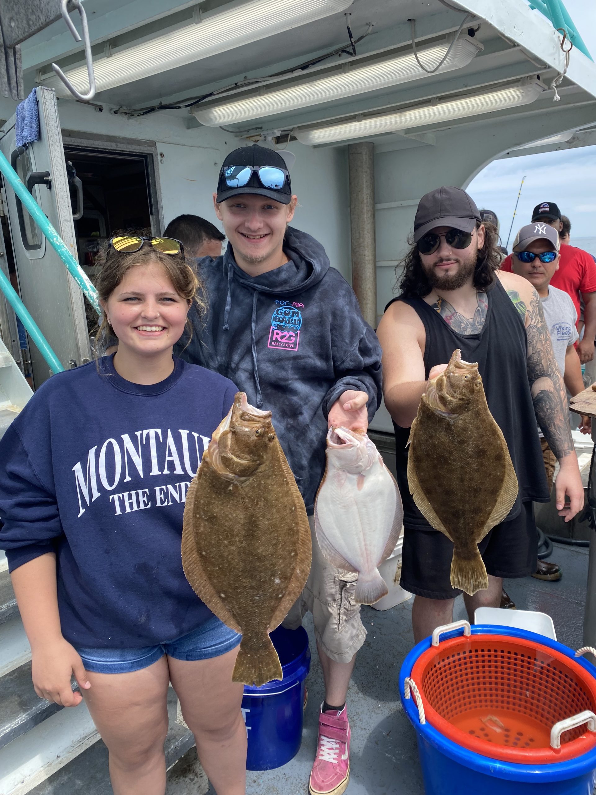 a group of people standing next to a stuffed animal