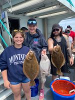 a group of people standing next to a stuffed animal