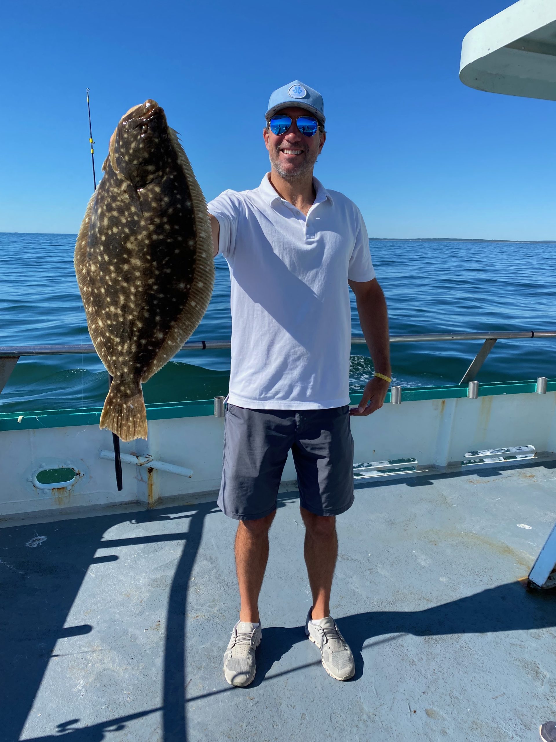 a man holding a fish in the water
