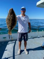 a man holding a fish in the water