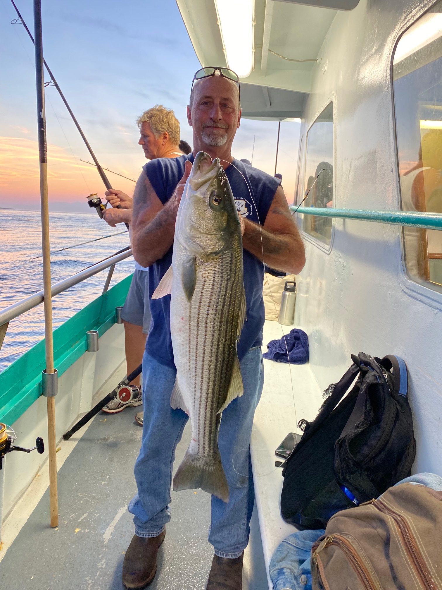a person holding a fish on a boat