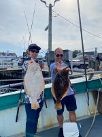 a man holding a fish on a boat