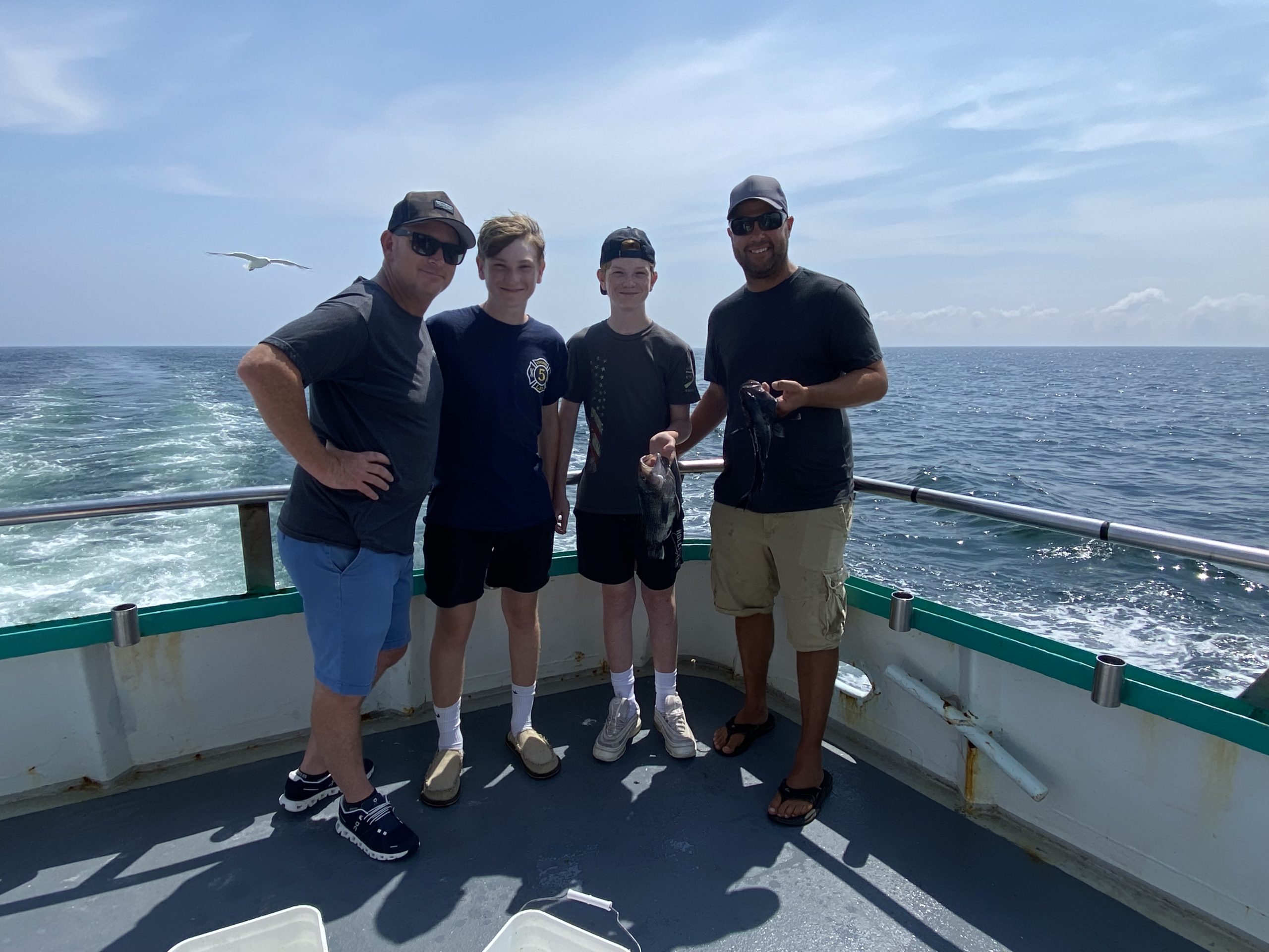 a group of people standing next to a body of water