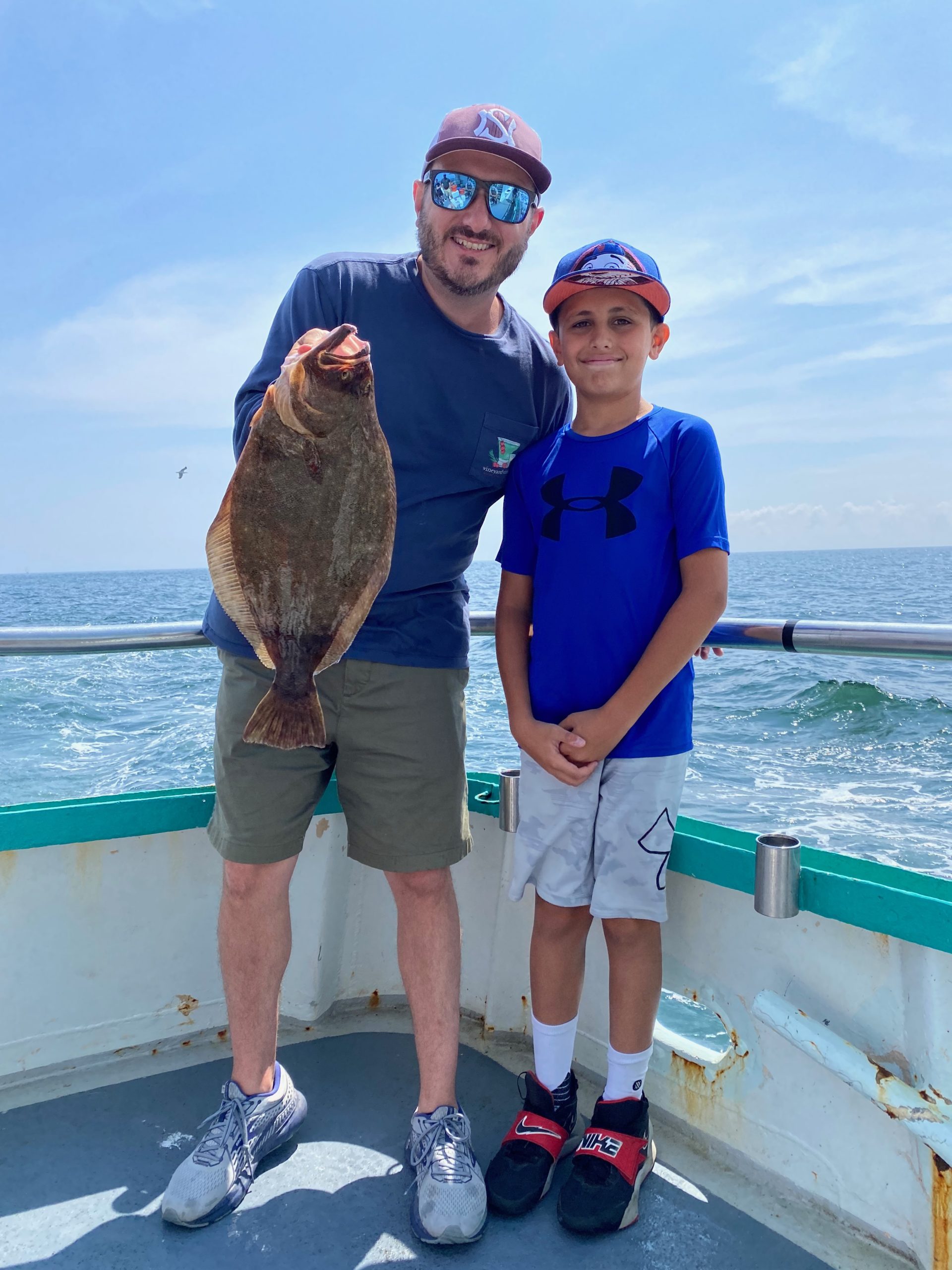 a man standing next to a body of water