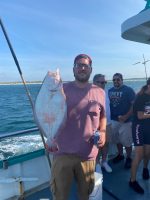 a man holding a fish in the water