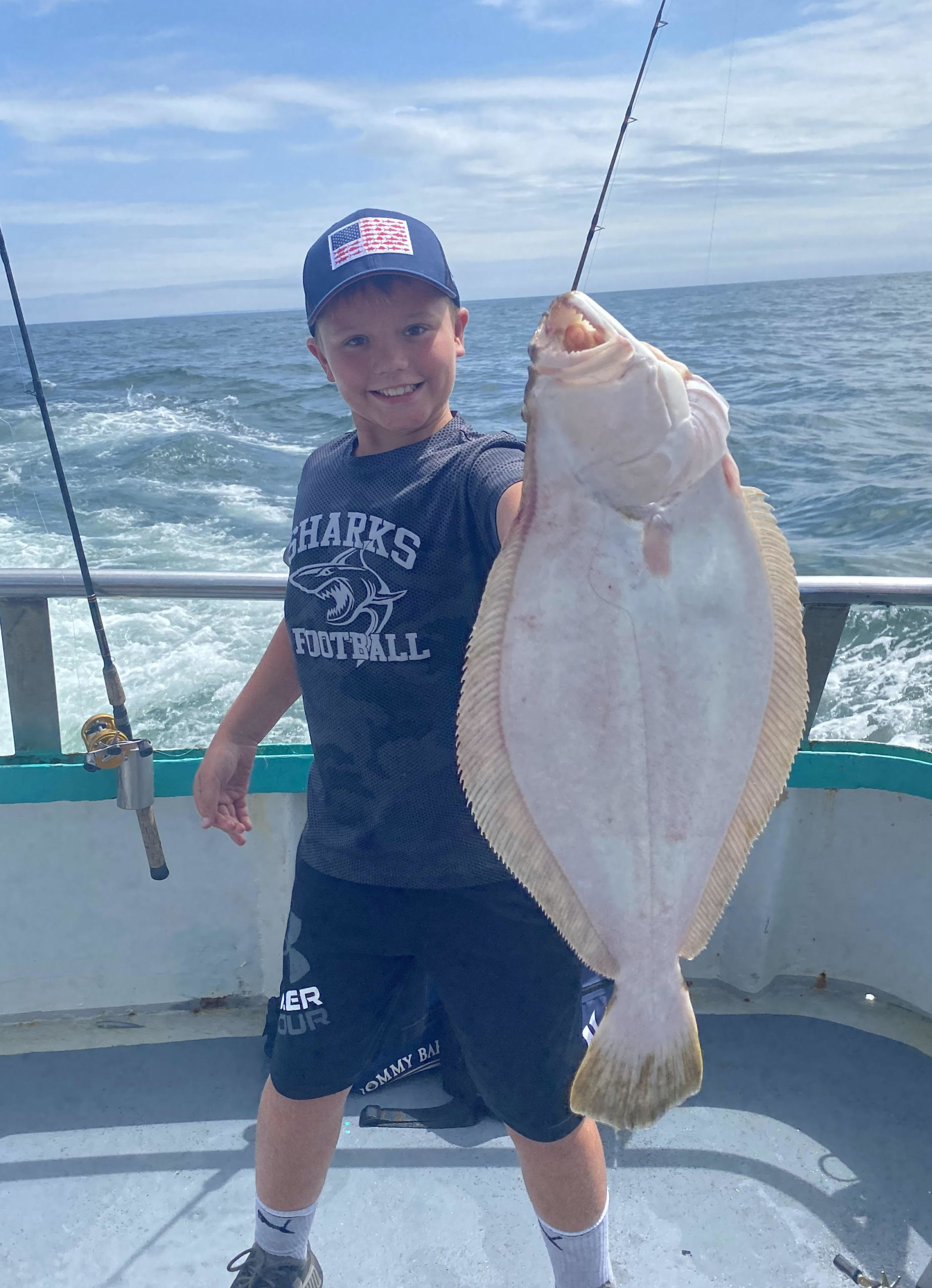 a man holding a fish in the water