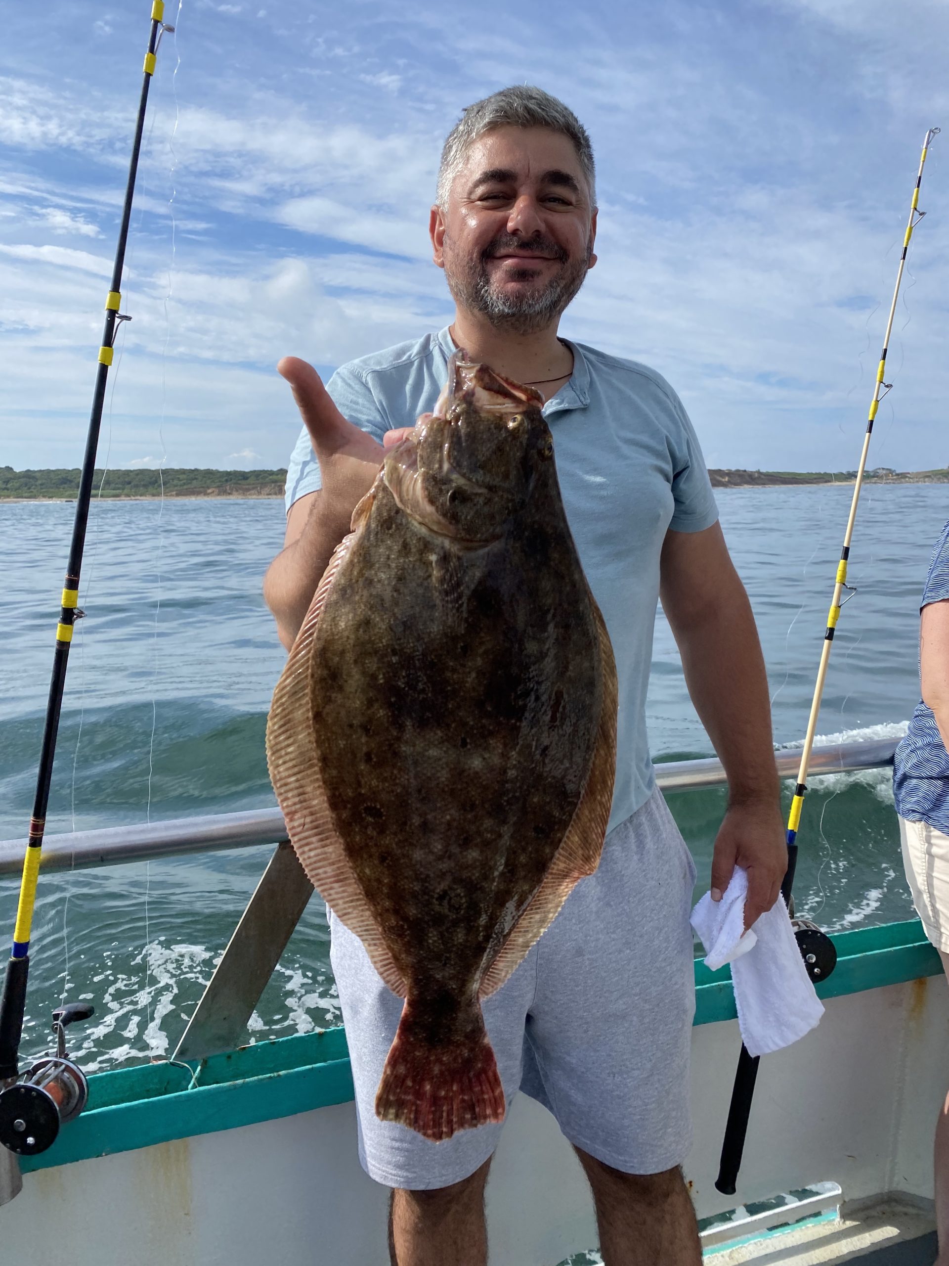 a man holding a fish in the water