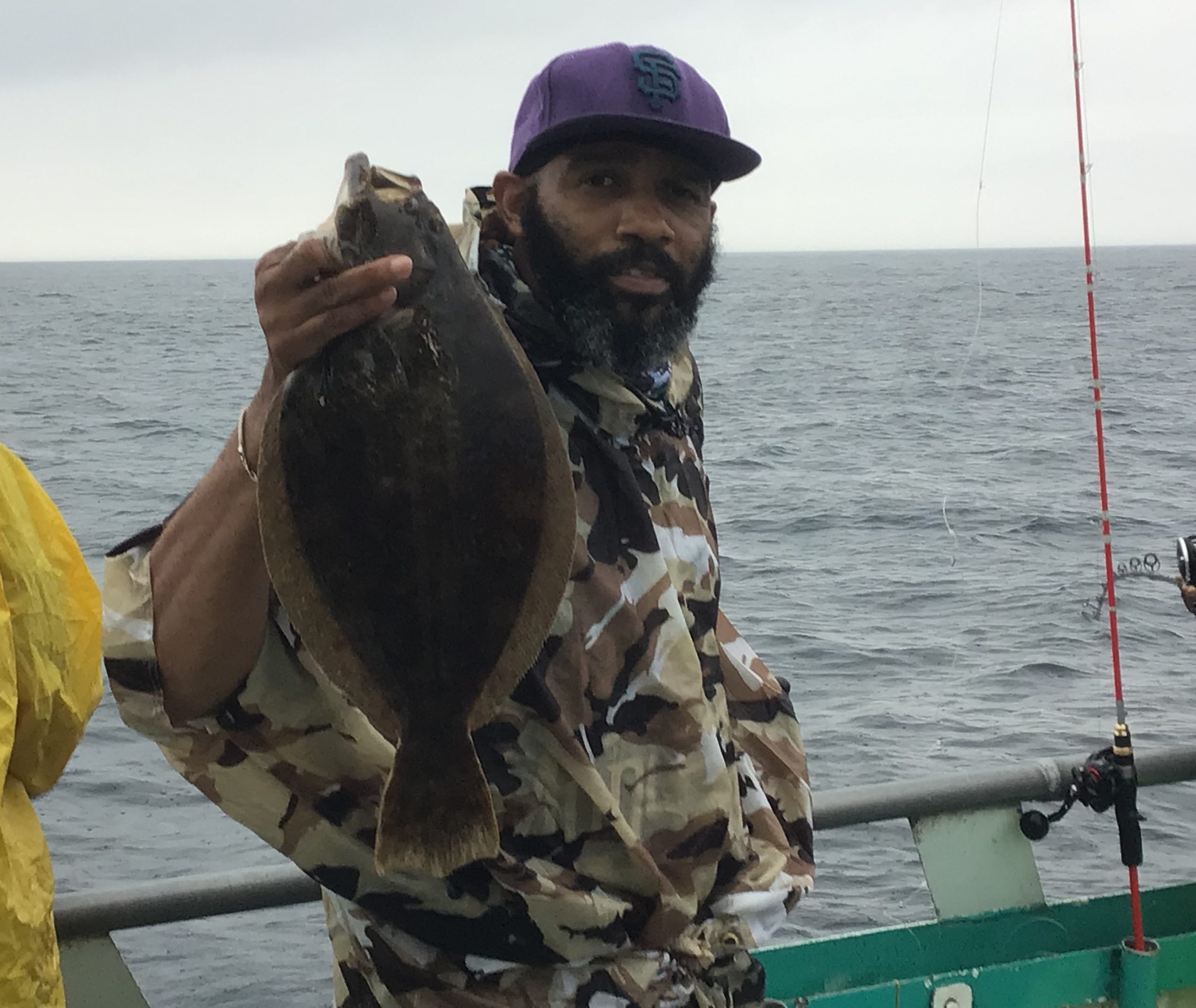 a man standing next to a body of water
