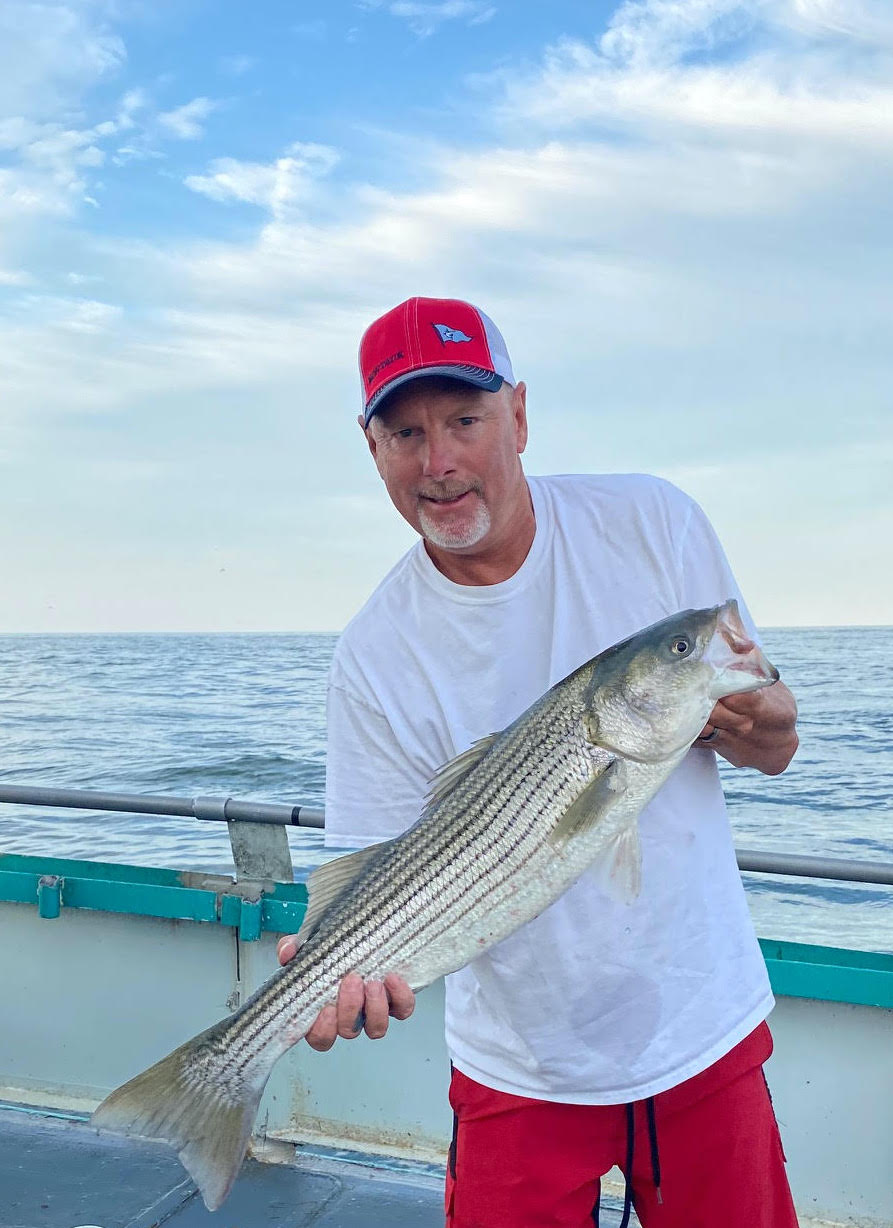 a man holding a fish in the water