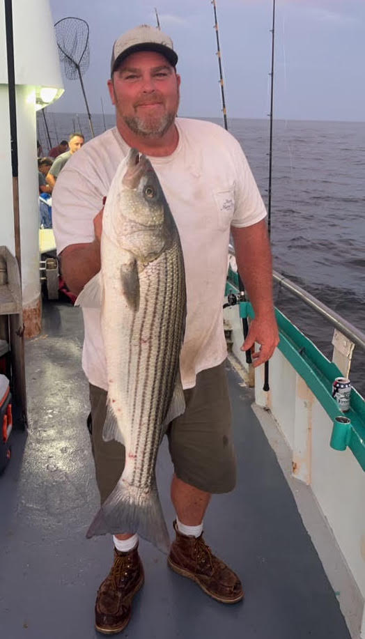 a man holding a fish